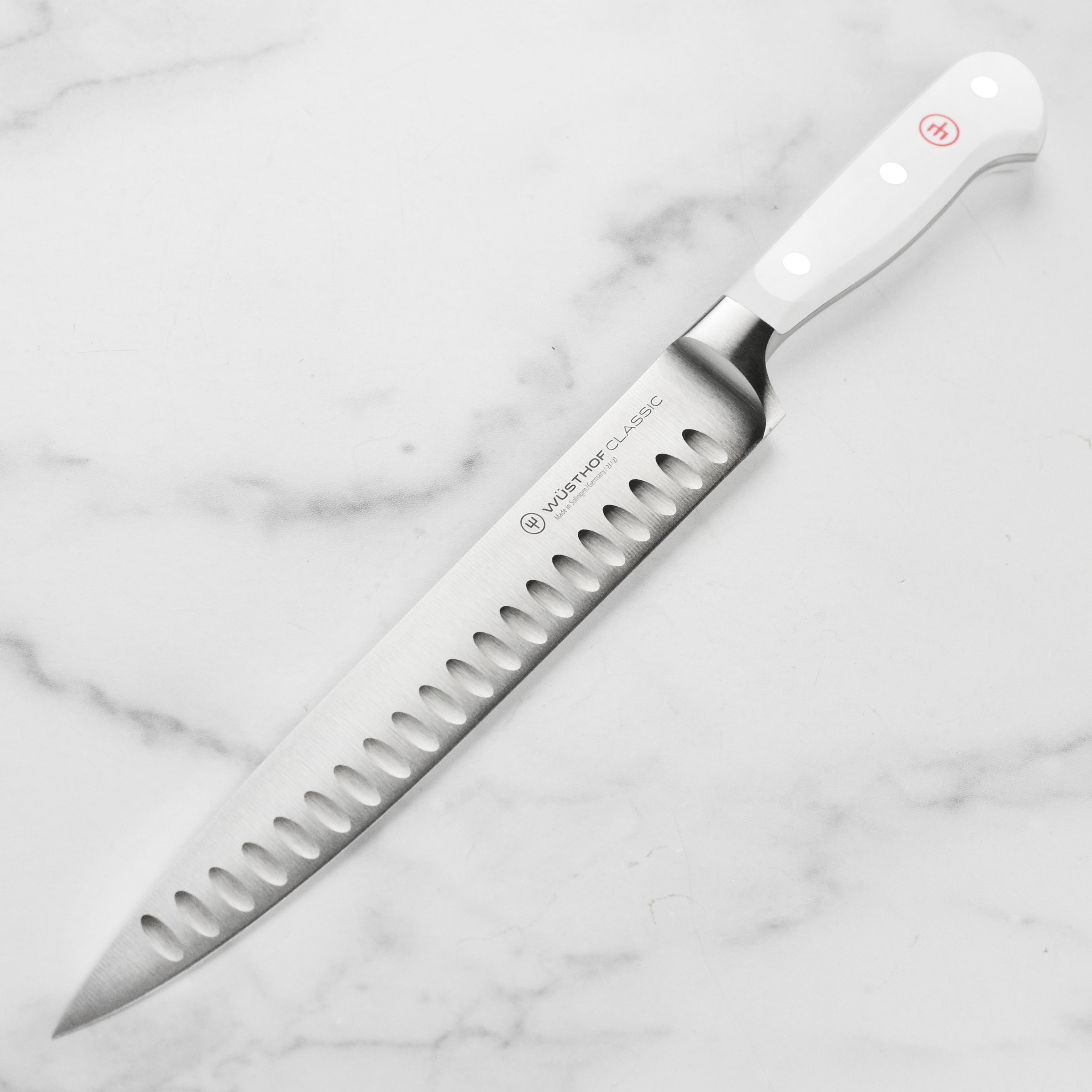 Wusthof Precision Edge 9-inch carving knife showcasing the hollow edge and sharp blade.