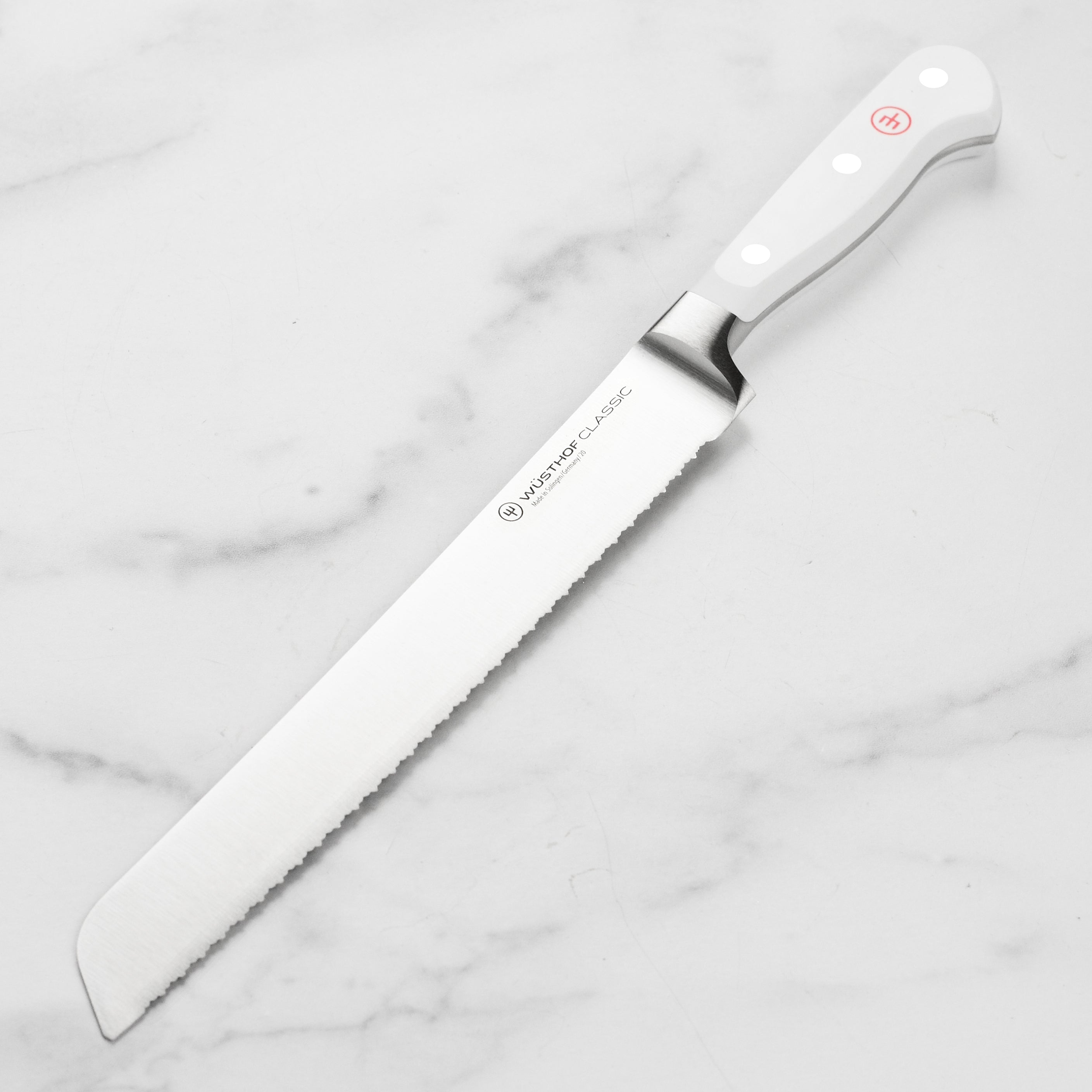 Wusthof Classic White 9-inch serrated bread knife slicing crusty artisanal bread