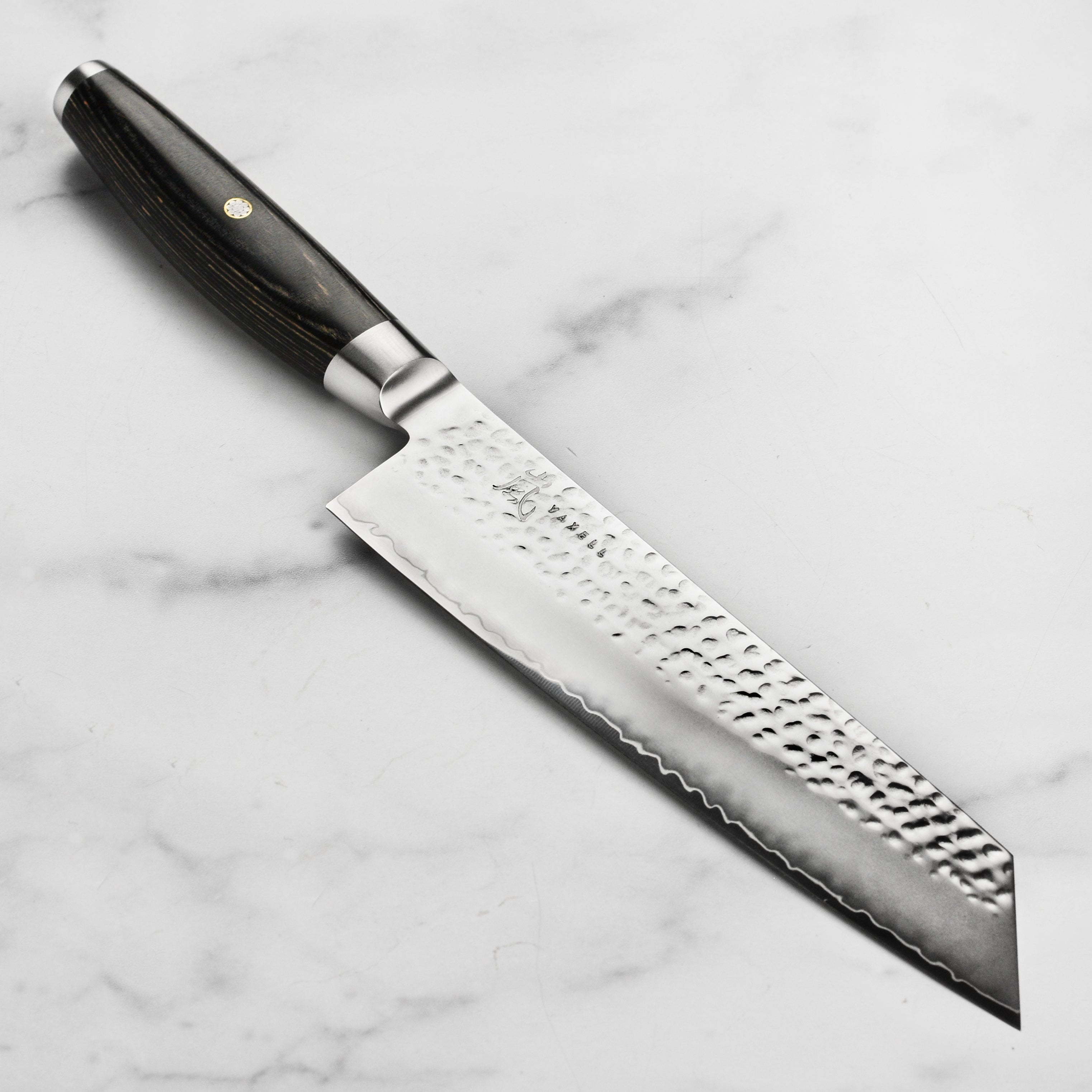 Close-up of Yaxell Ketu SG2 Kiritsuke Knife with detailed hammered finish.