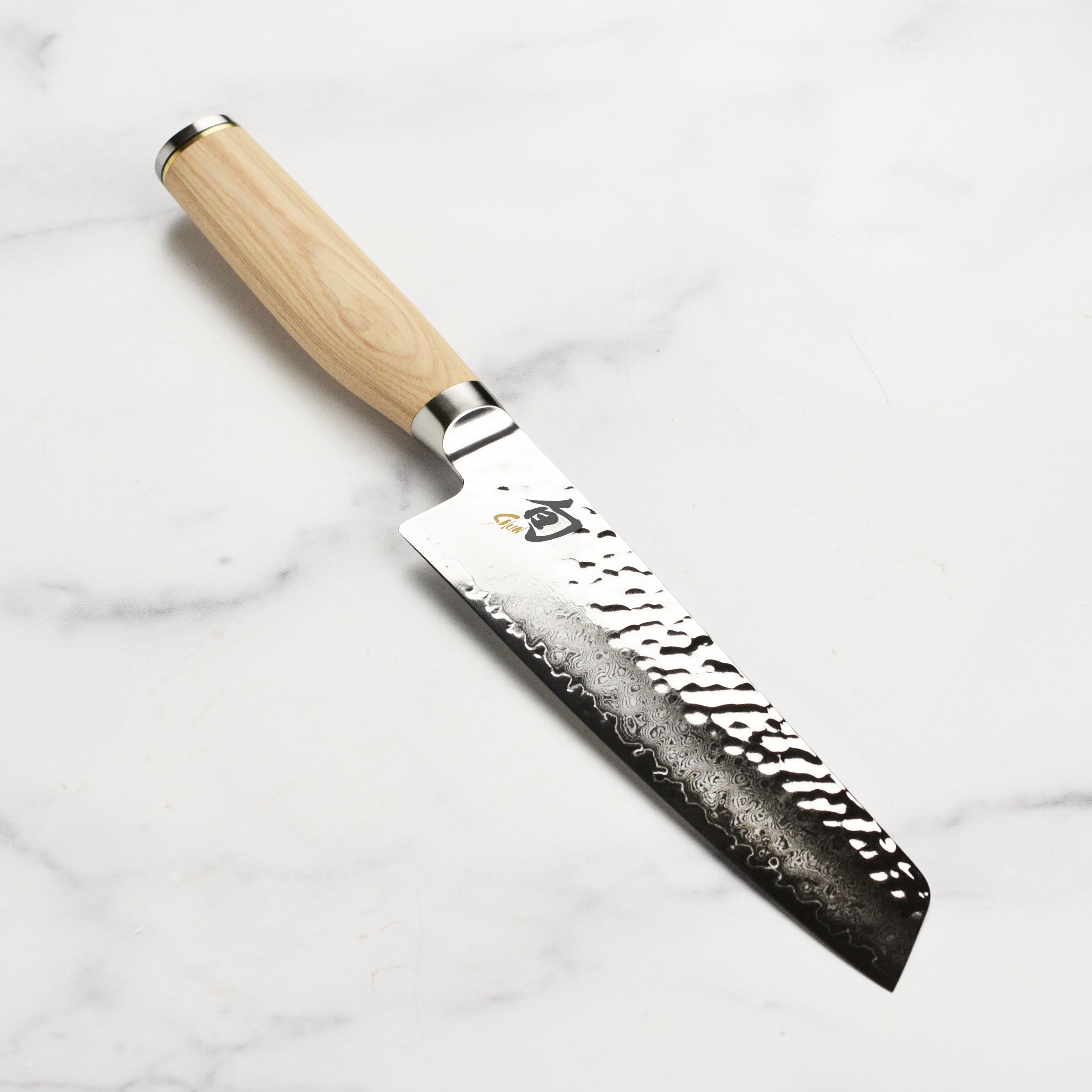 Shun Premier Blonde 6.5-inch utility knife with Damascus layered blade on cutting board