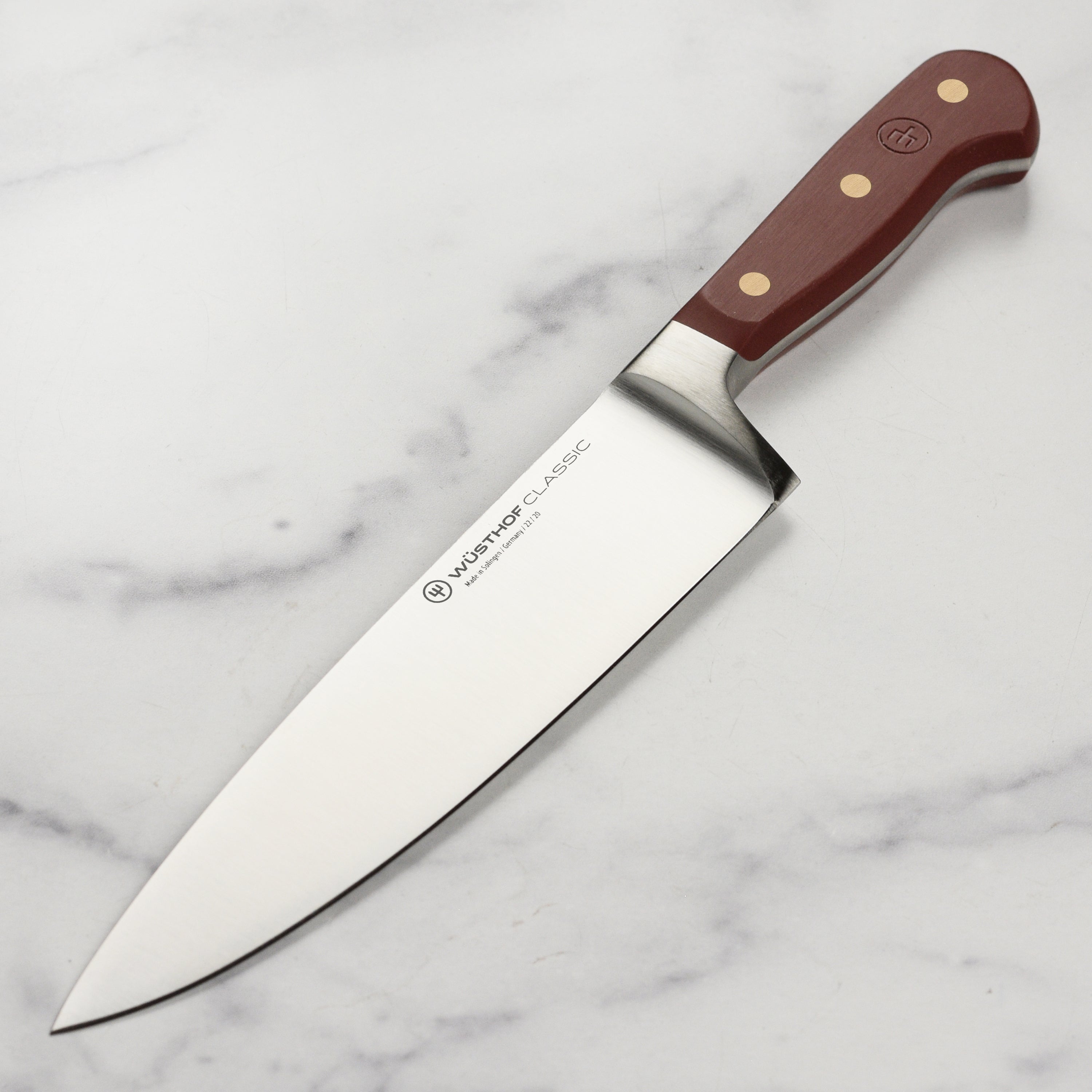 Close-up of the Wusthof Classic 8-Inch Chef's Knife blade, highlighting its sharp edge and craftsmanship.