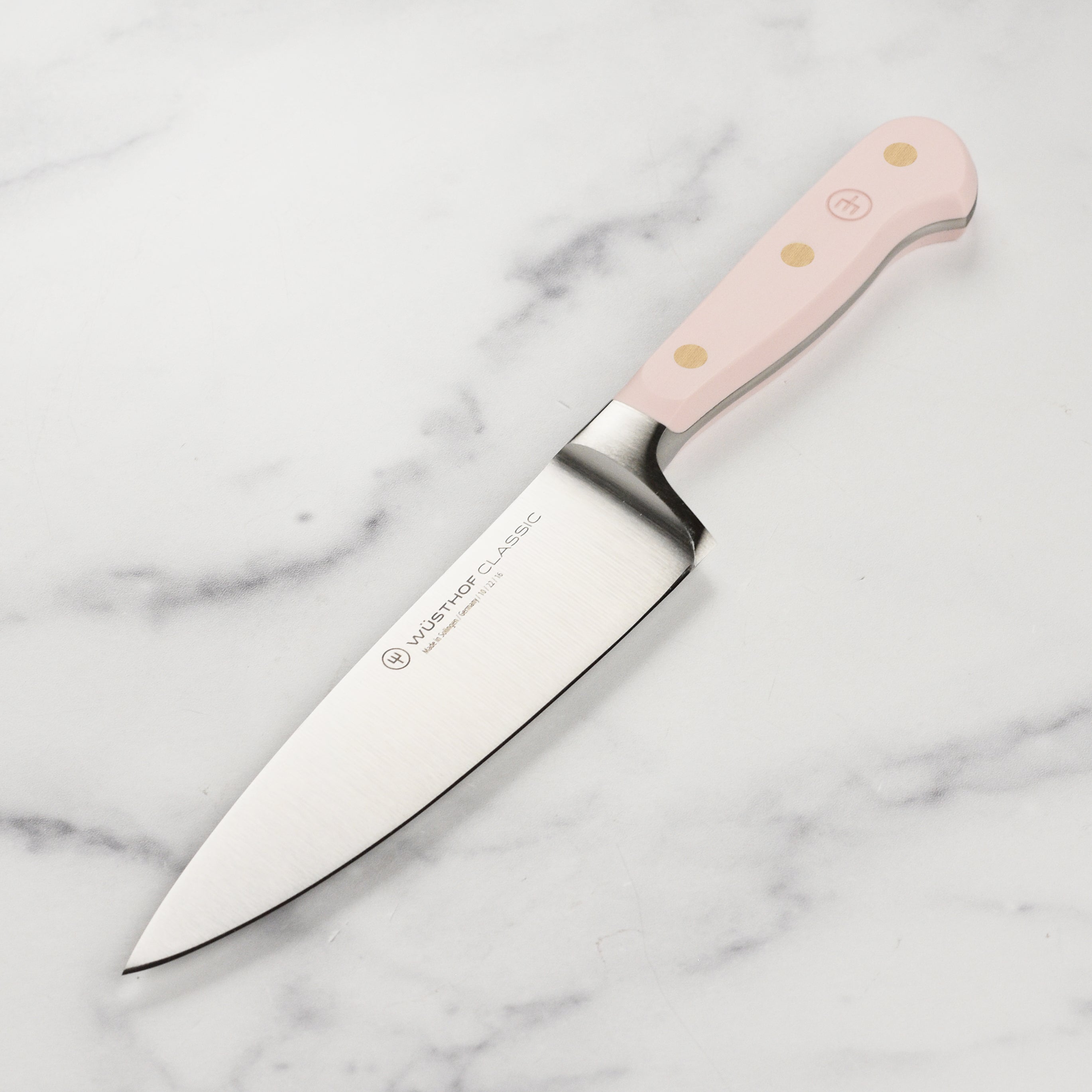 Close-up of the Wusthof Classic Himalayan Salt Chef Knife highlighting its sharp blade and ergonomic design.