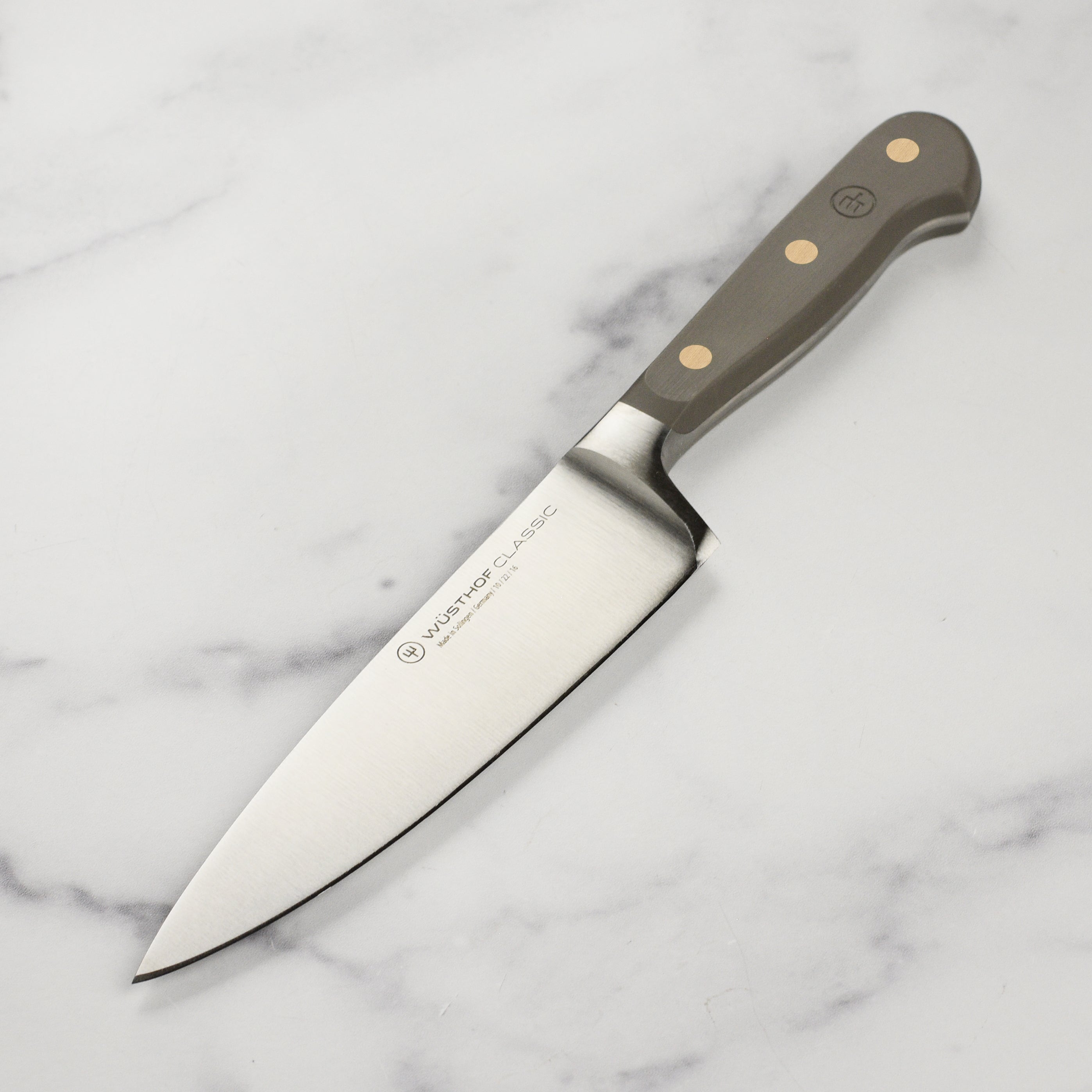 Wusthof Classic 6-Inch Chef Knife showcasing the sharp blade and POM handle.