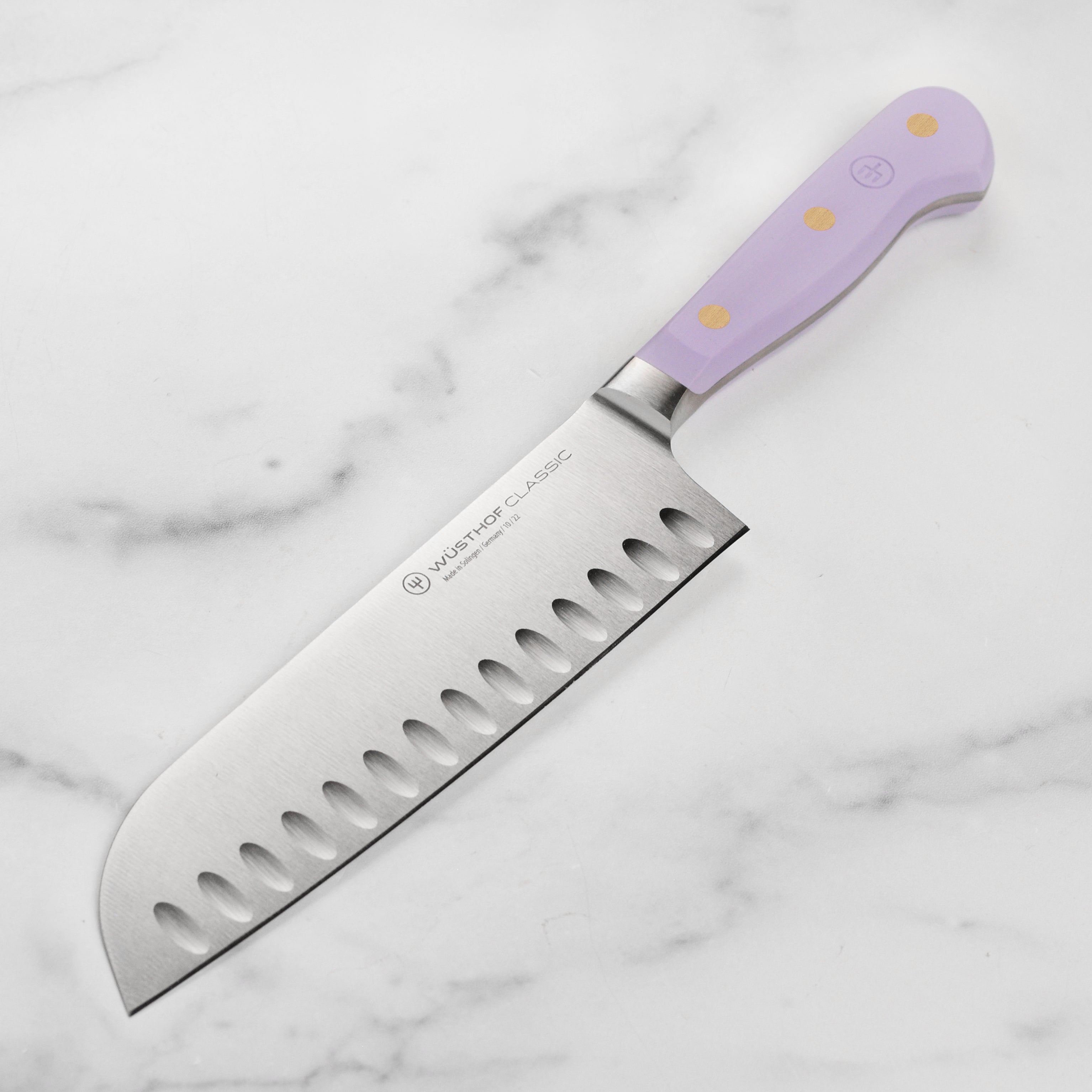 Wusthof Classic 7-Inch Santoku Knife with Purple Yam handle, angled view highlighting the sharp blade.
