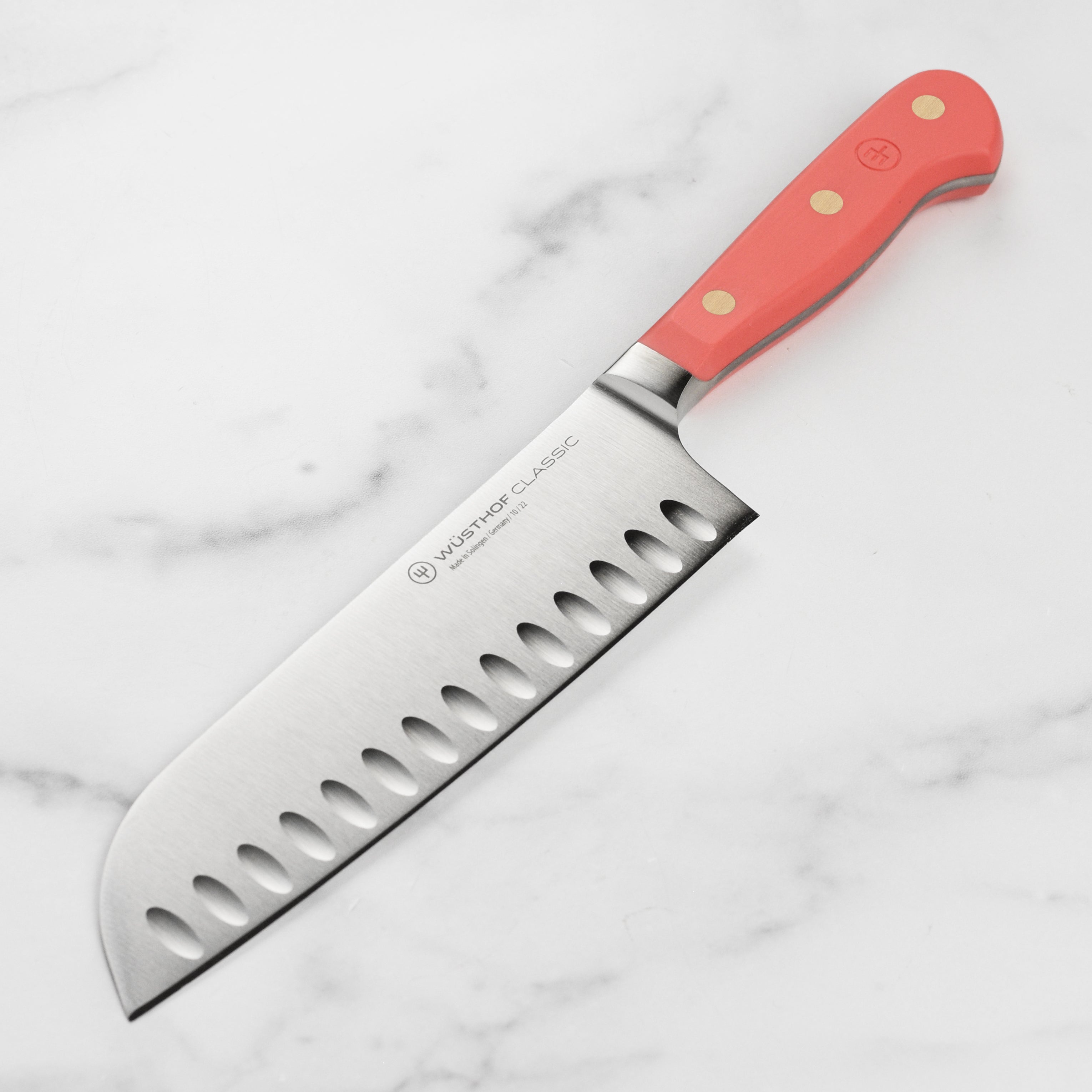 Wüsthof Classic 7-inch Santoku knife showing sharp blade and coral peach handle for precision slicing