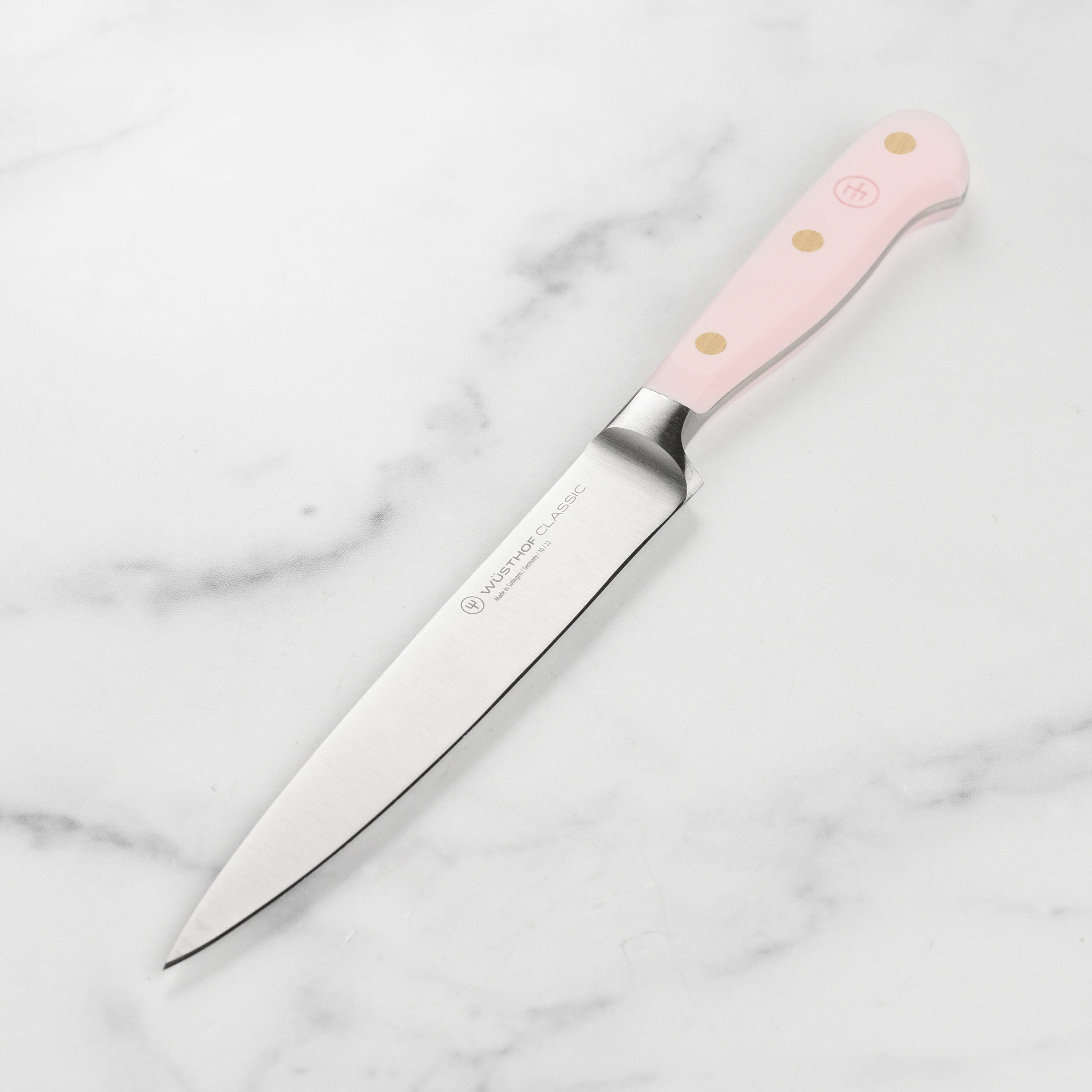 Close-up side view of Wusthof utility knife blade showing the Himalayan salt finish