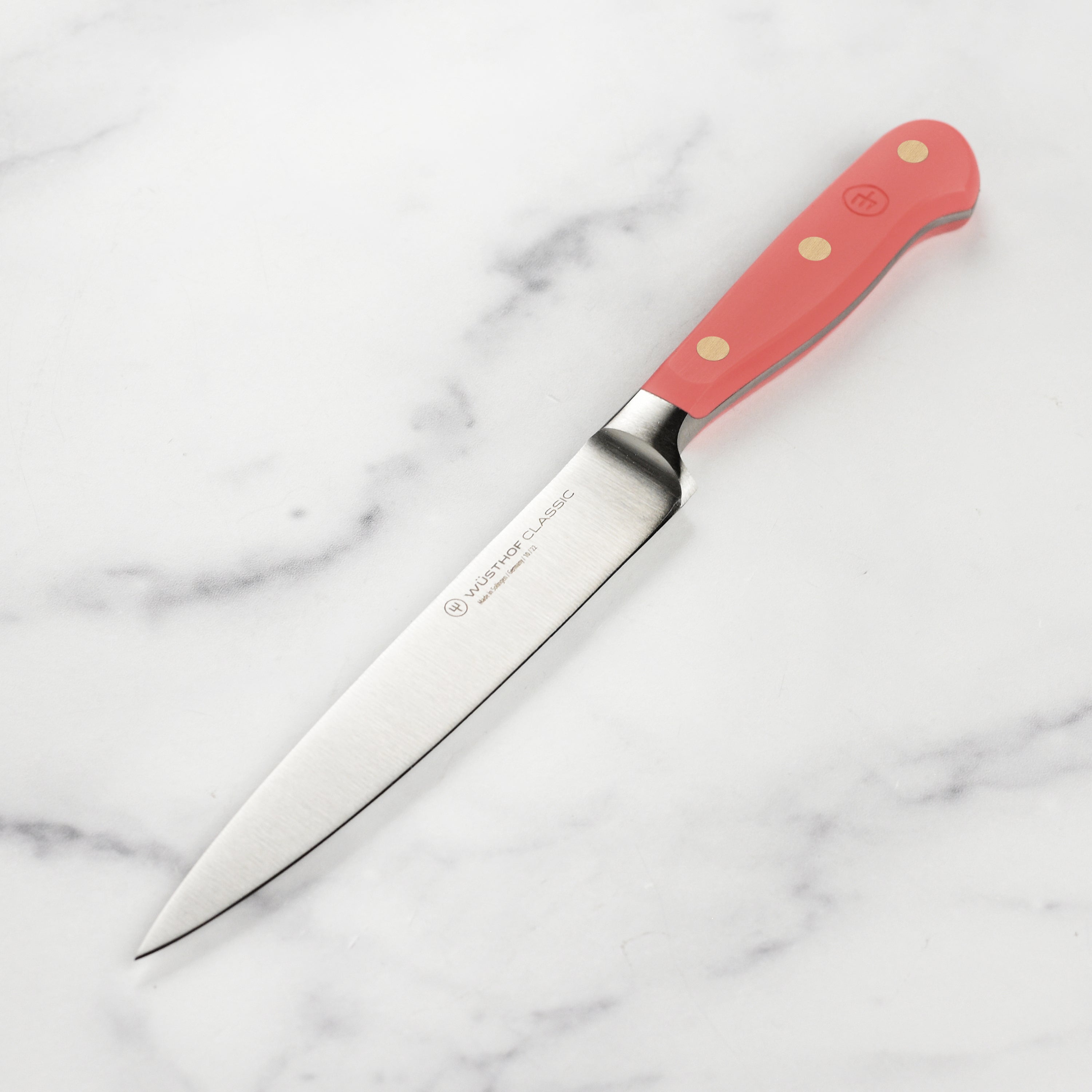 Wusthof Classic utility knife from above, highlighting the sharp edge and ergonomic handle.