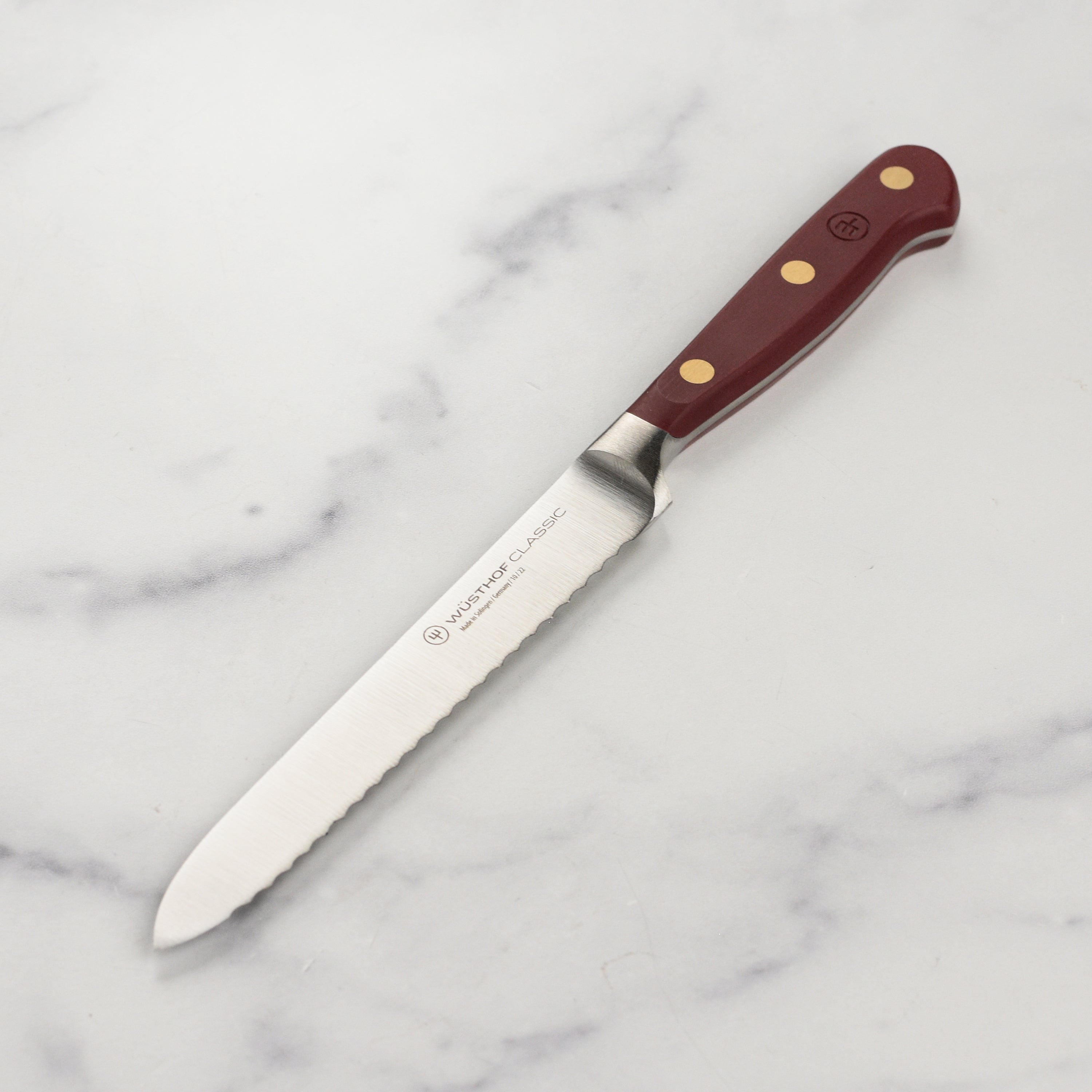 Close-up of the Wusthof Classic serrated utility knife highlighting its precision edge.