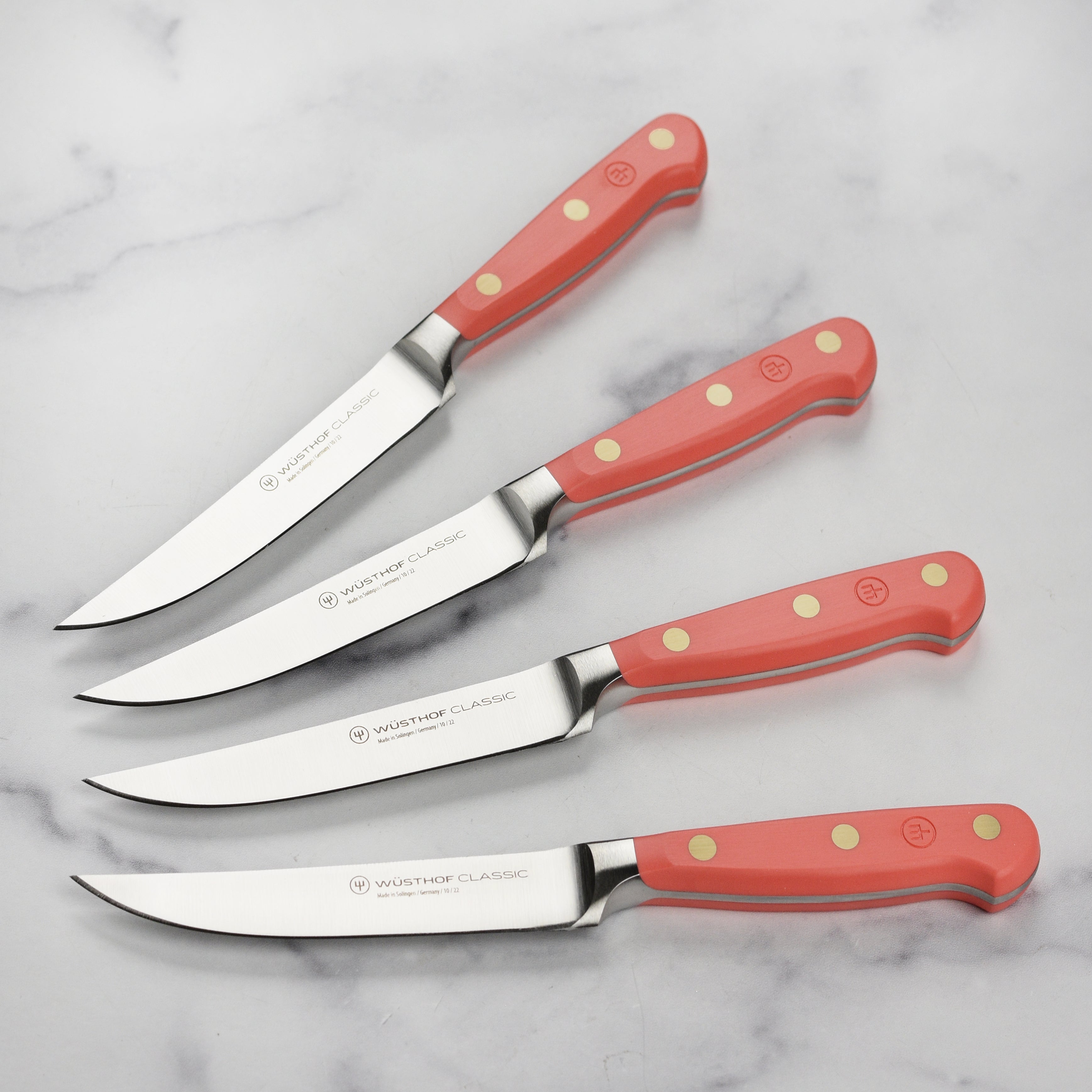 Close-up view of the Wusthof Coral Peach Steak Knife Set showcasing the high-carbon steel blades and precision craftsmanship.