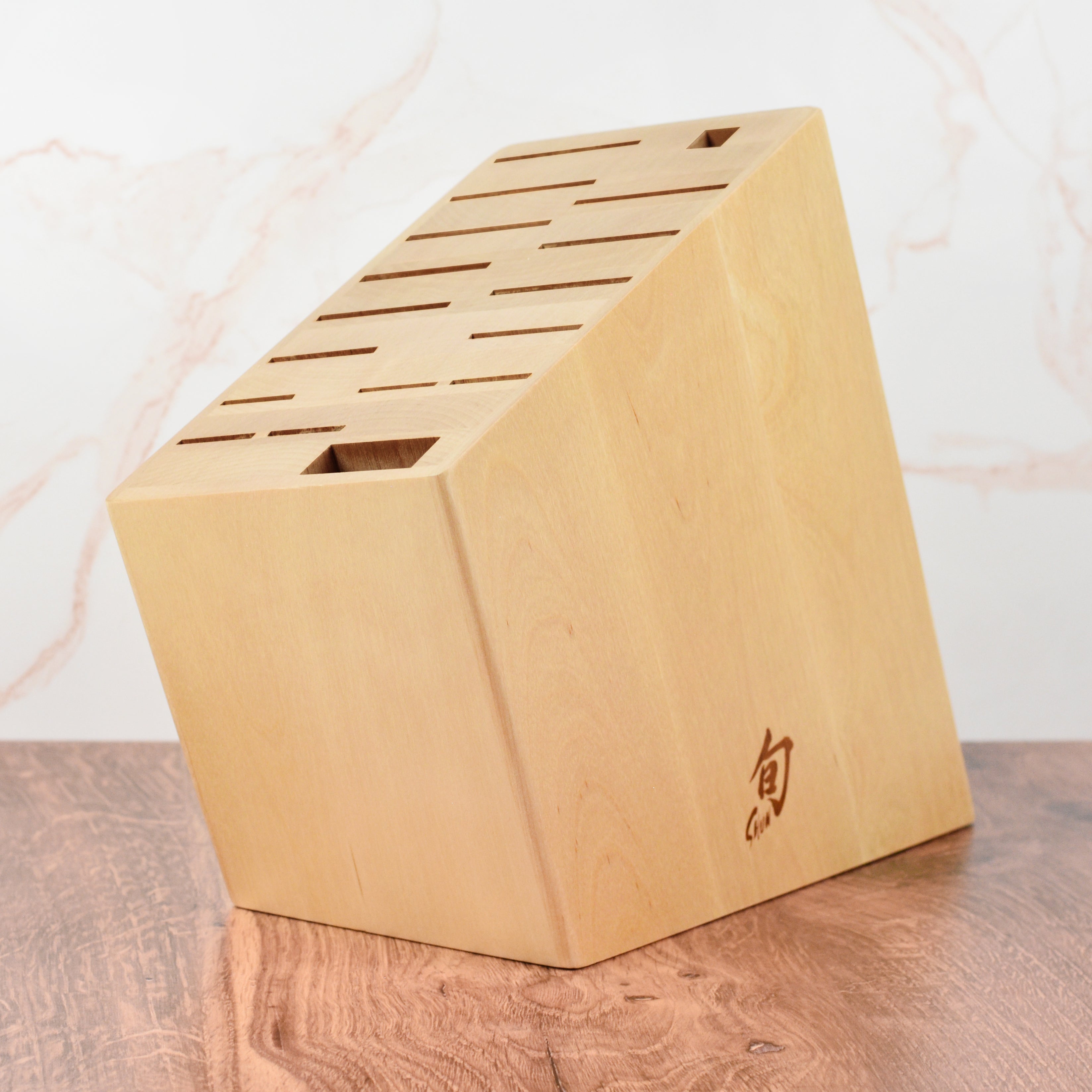 Angled view of the birch knife block showcasing its 17 slots for kitchen cutlery.
