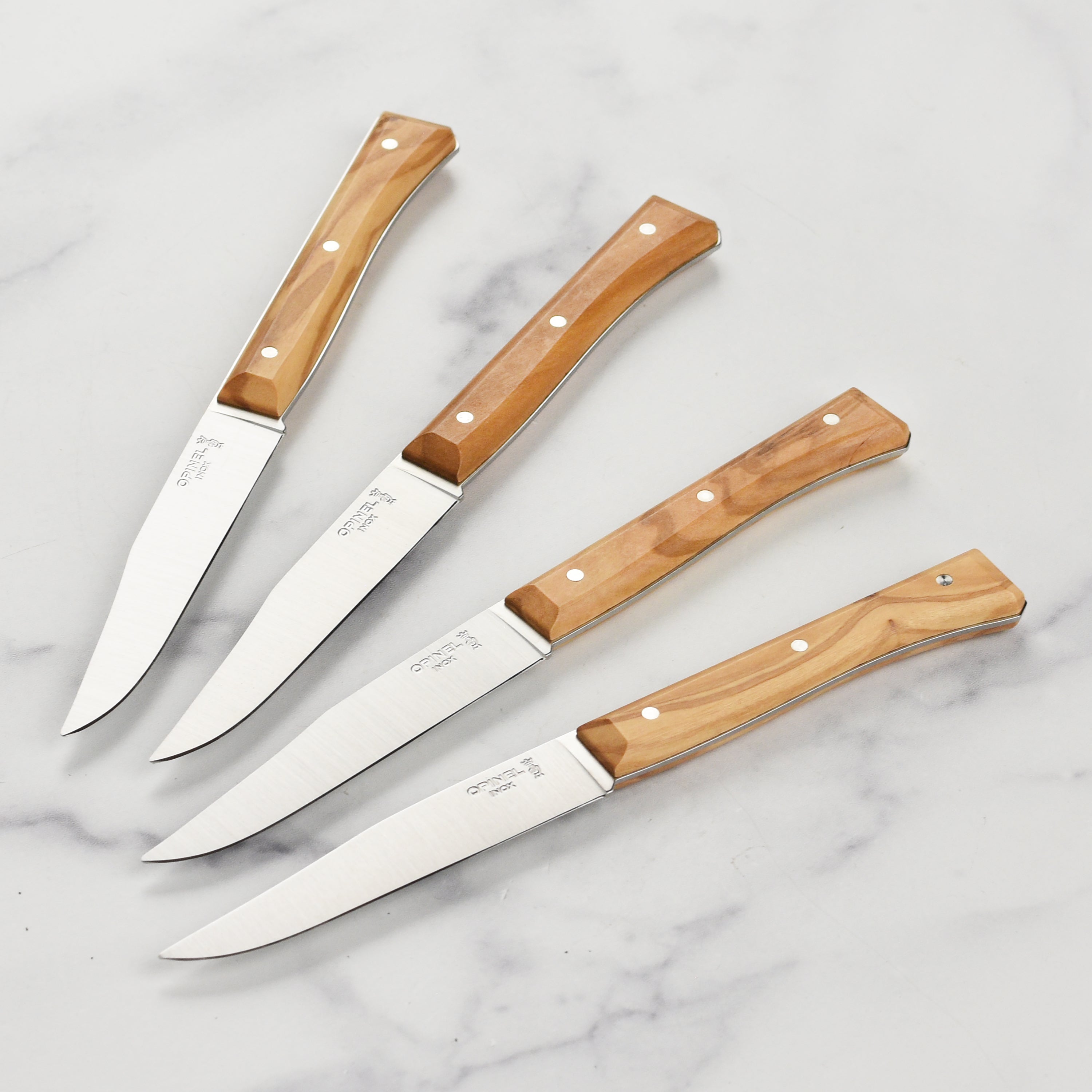 Close-up of the premium olive wood steak knife set showcasing the ergonomic handles.
