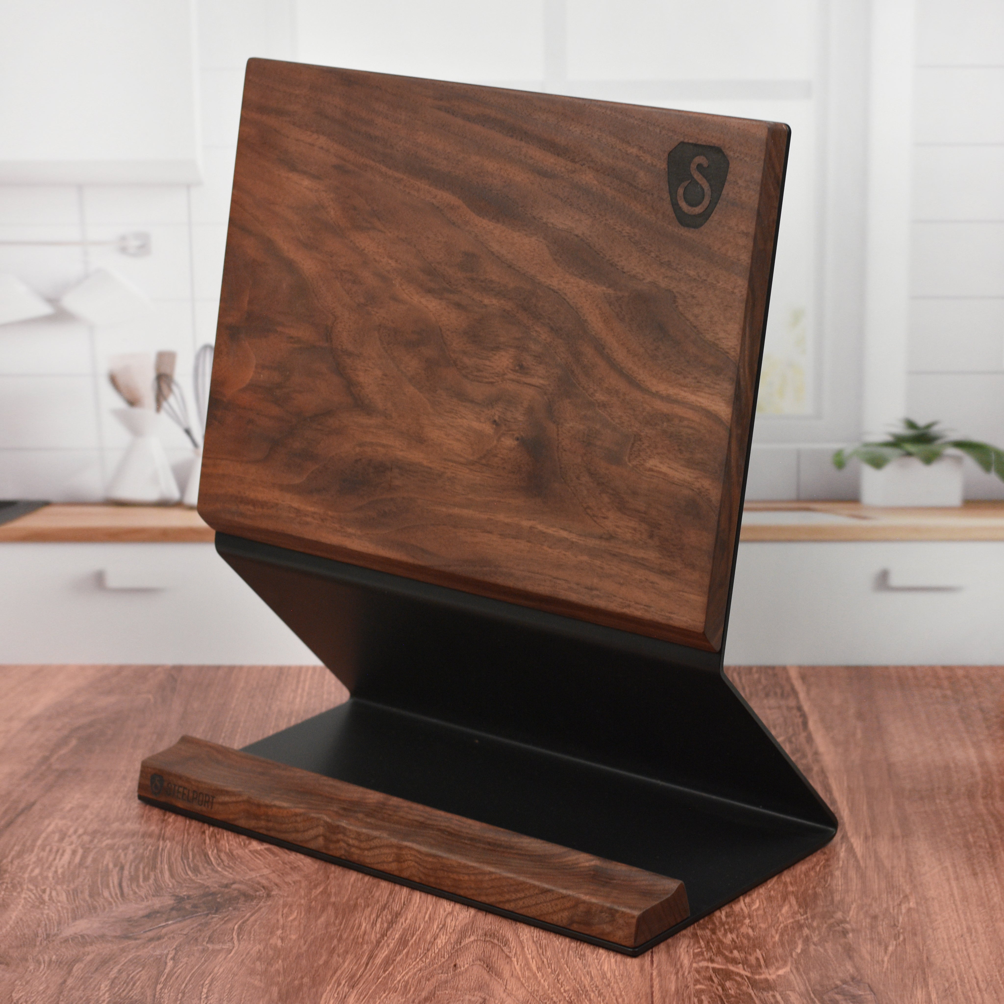Close-up of the walnut magnetic knife holder showing knives secured with magnets