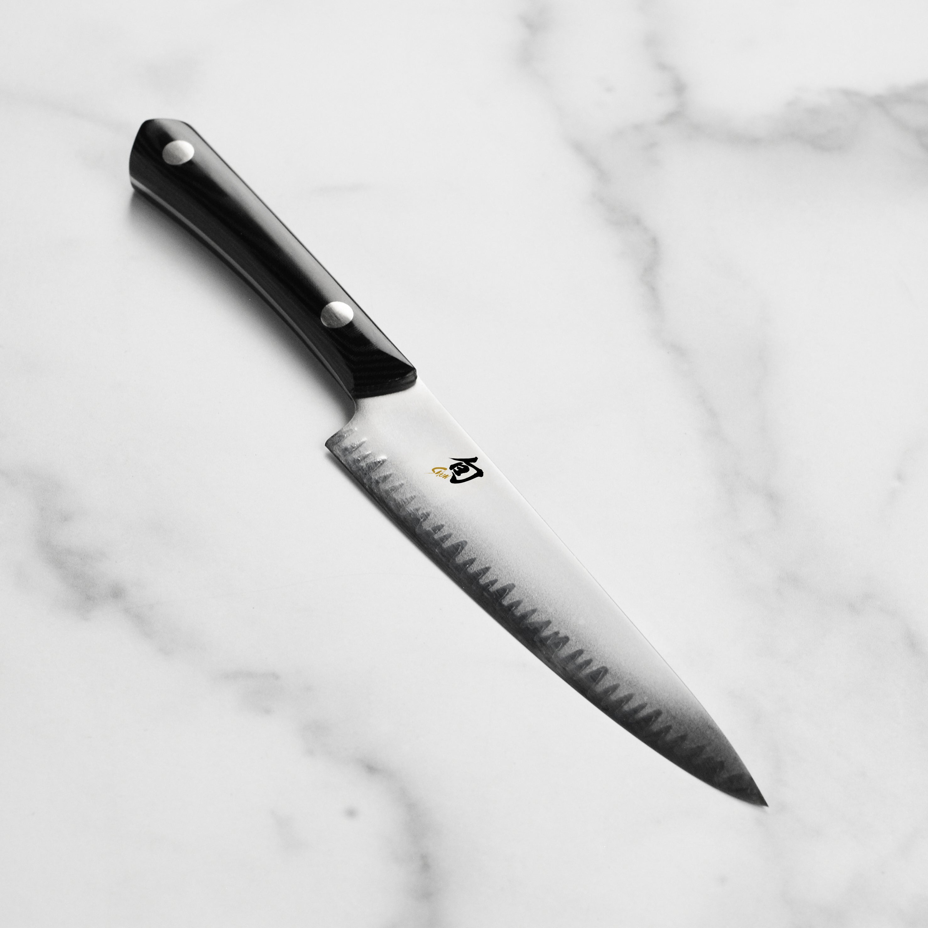 Japanese utility knife with full-tang handle and sharp edge for precision cutting