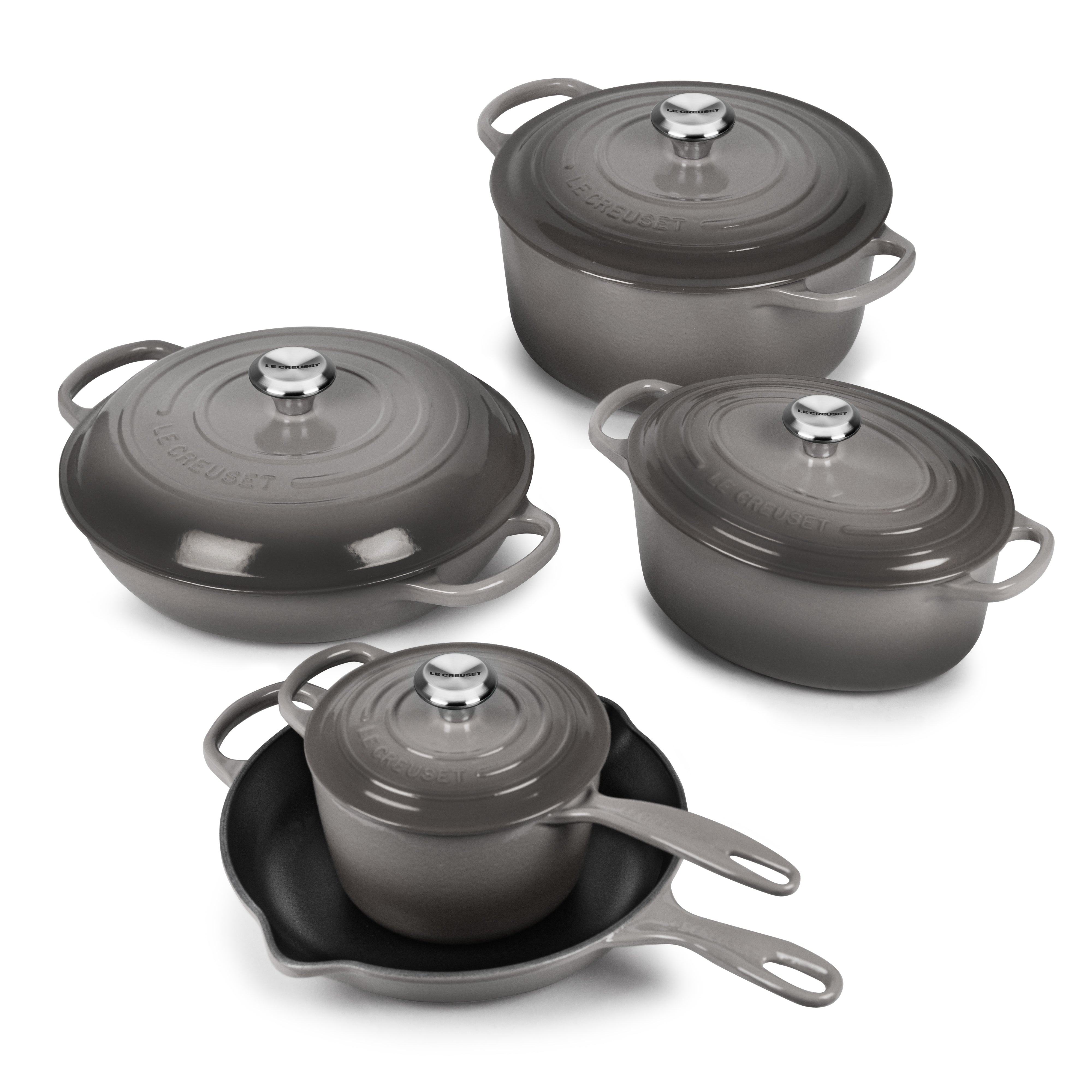 Le Creuset 9-Piece Signature Cast Iron Cookware Set showcasing vibrant colors and ergonomic handles.