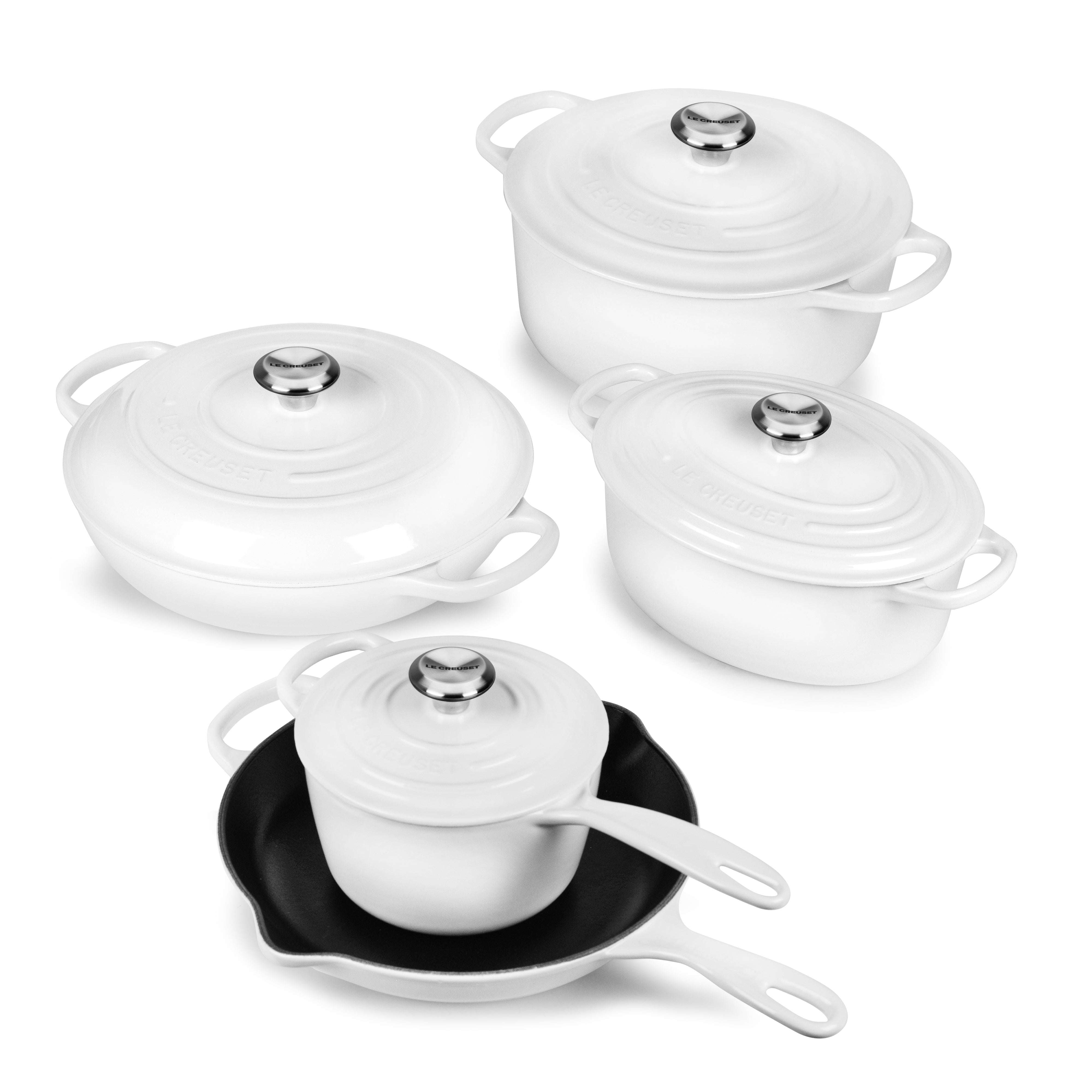 Close-up of Le Creuset Premium Enameled Cast Iron Cookware Set highlighting the glossy finish and ergonomic handles.