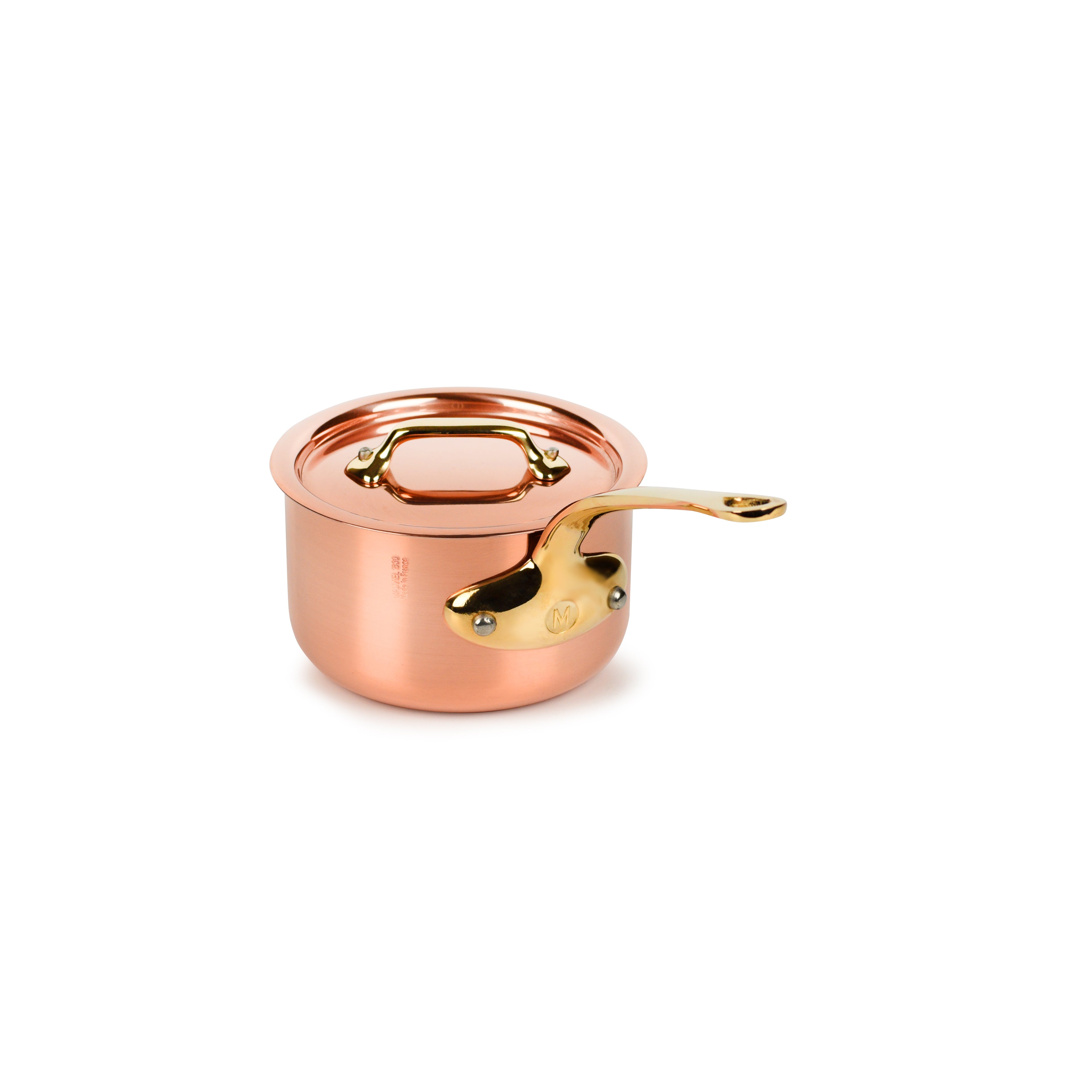 Close-up of Mauviel copper saucepan with lid showing the polished copper and bronze handle