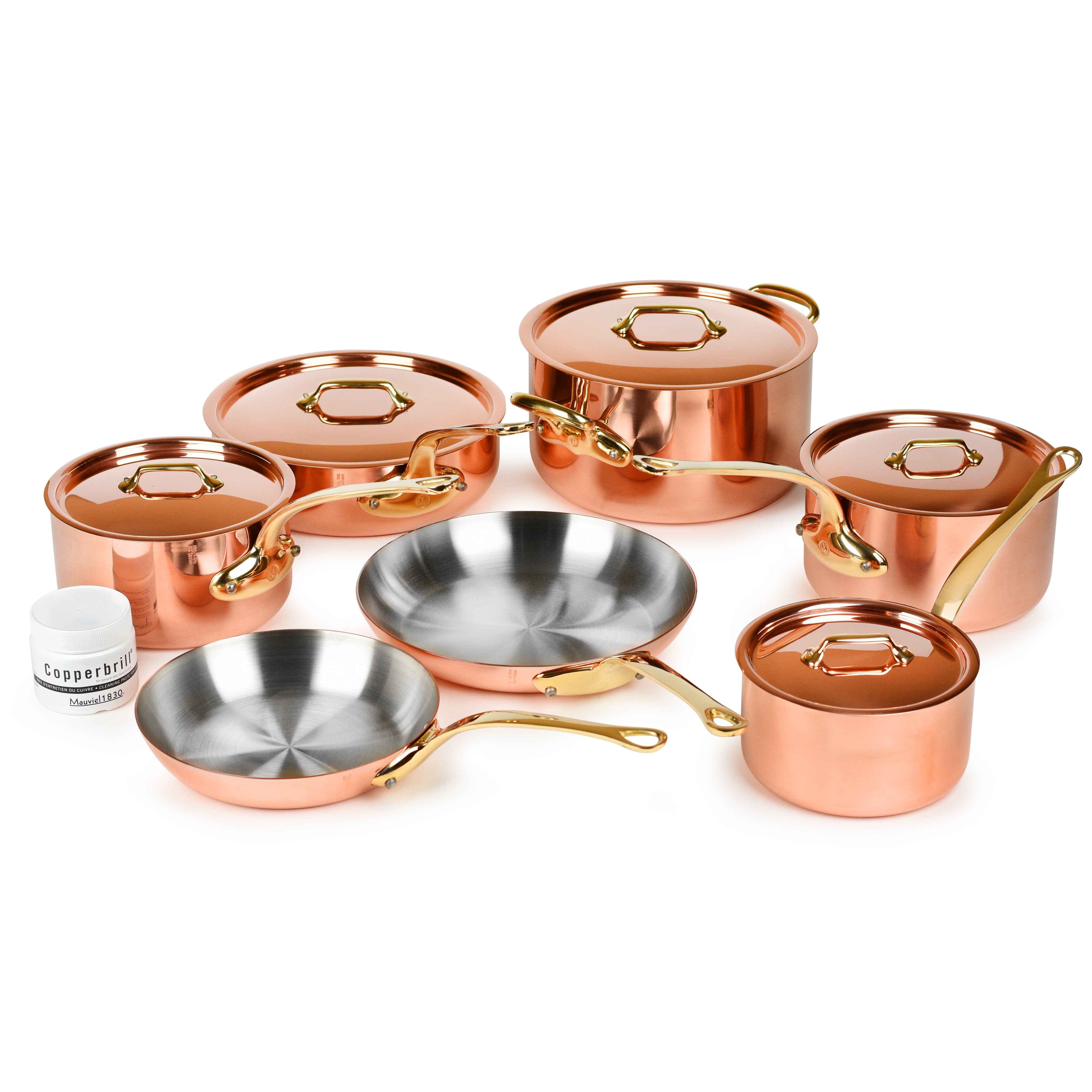 Mauviel M200B copper cookware set displayed on a kitchen countertop, highlighting its elegant design and bronze handles.