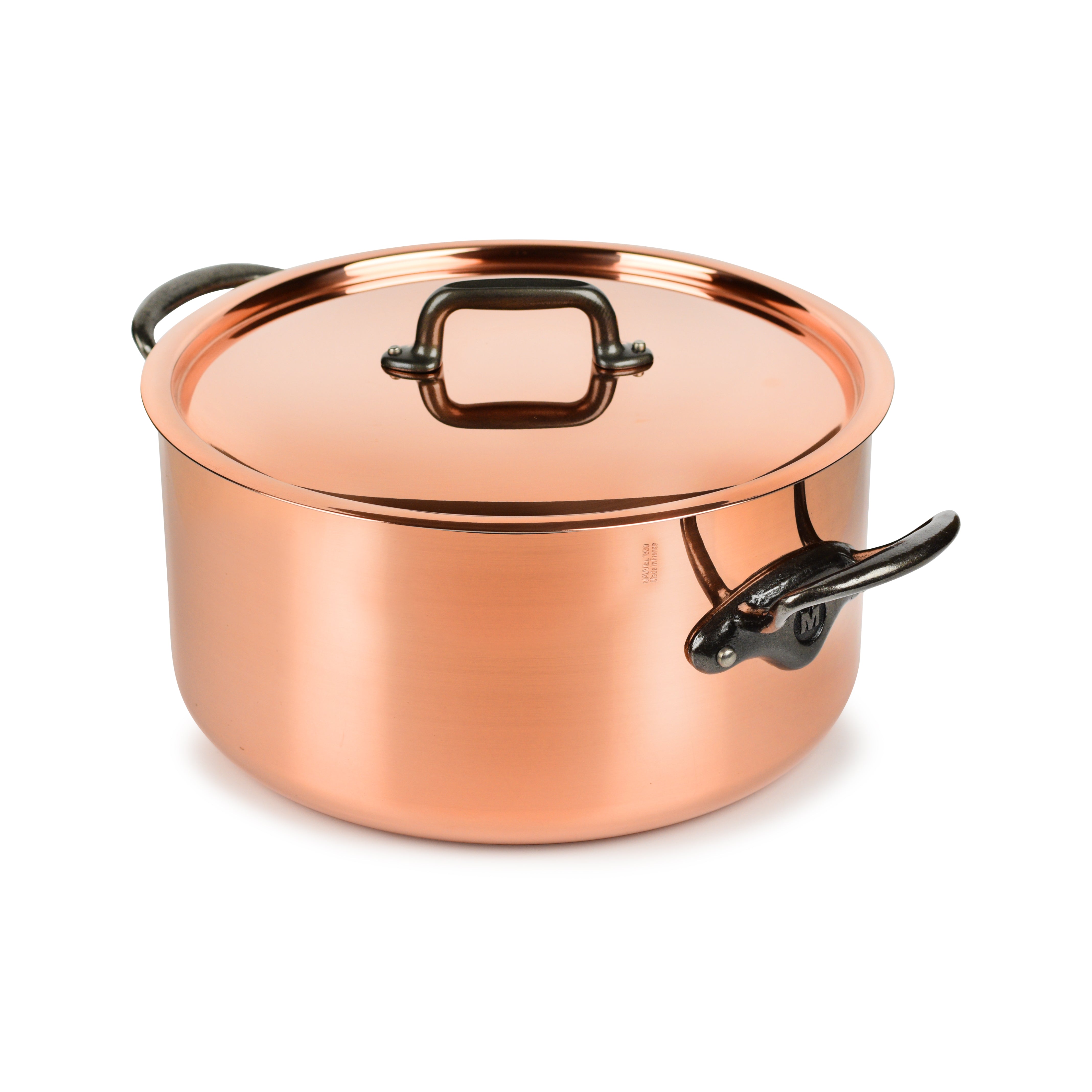 Mauviel copper stock pot with lid on stovetop, showcasing its shiny copper exterior and sturdy handle