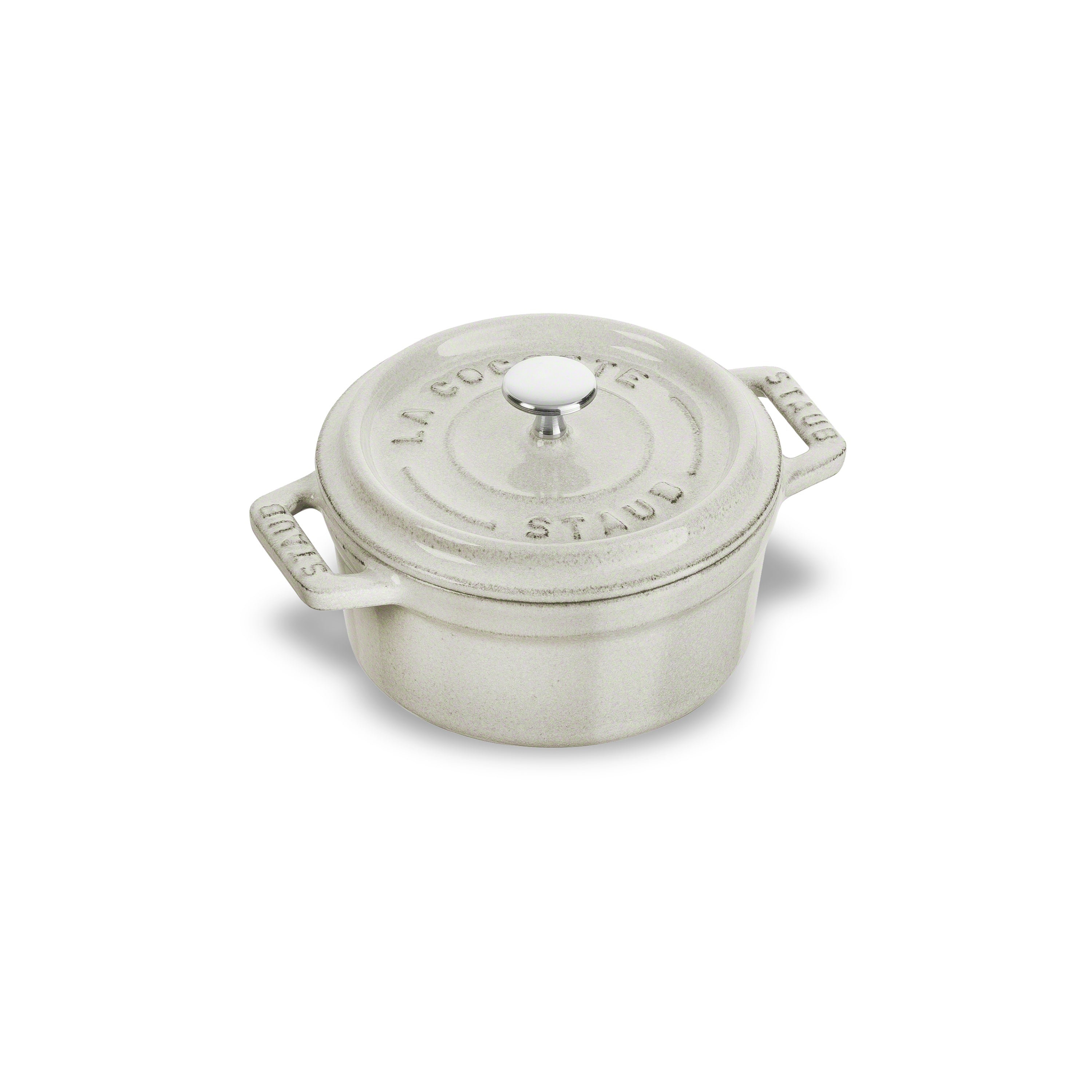 Close-up of the White Truffle Mini Round Enameled Dutch Oven showcasing its textured interior and lid.