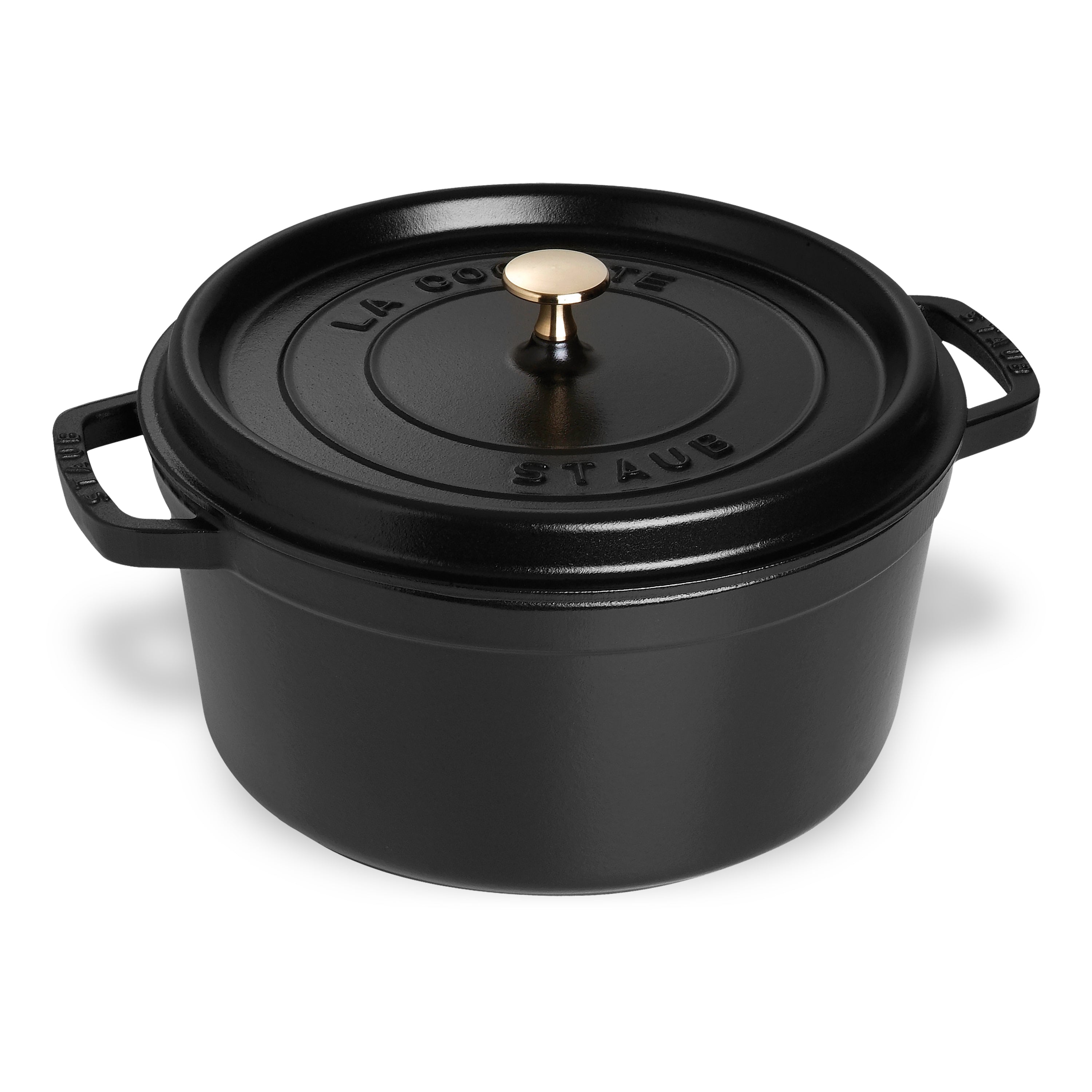 Staub 9-Quart Round Dutch Oven on stovetop showing enameled cast iron finish.