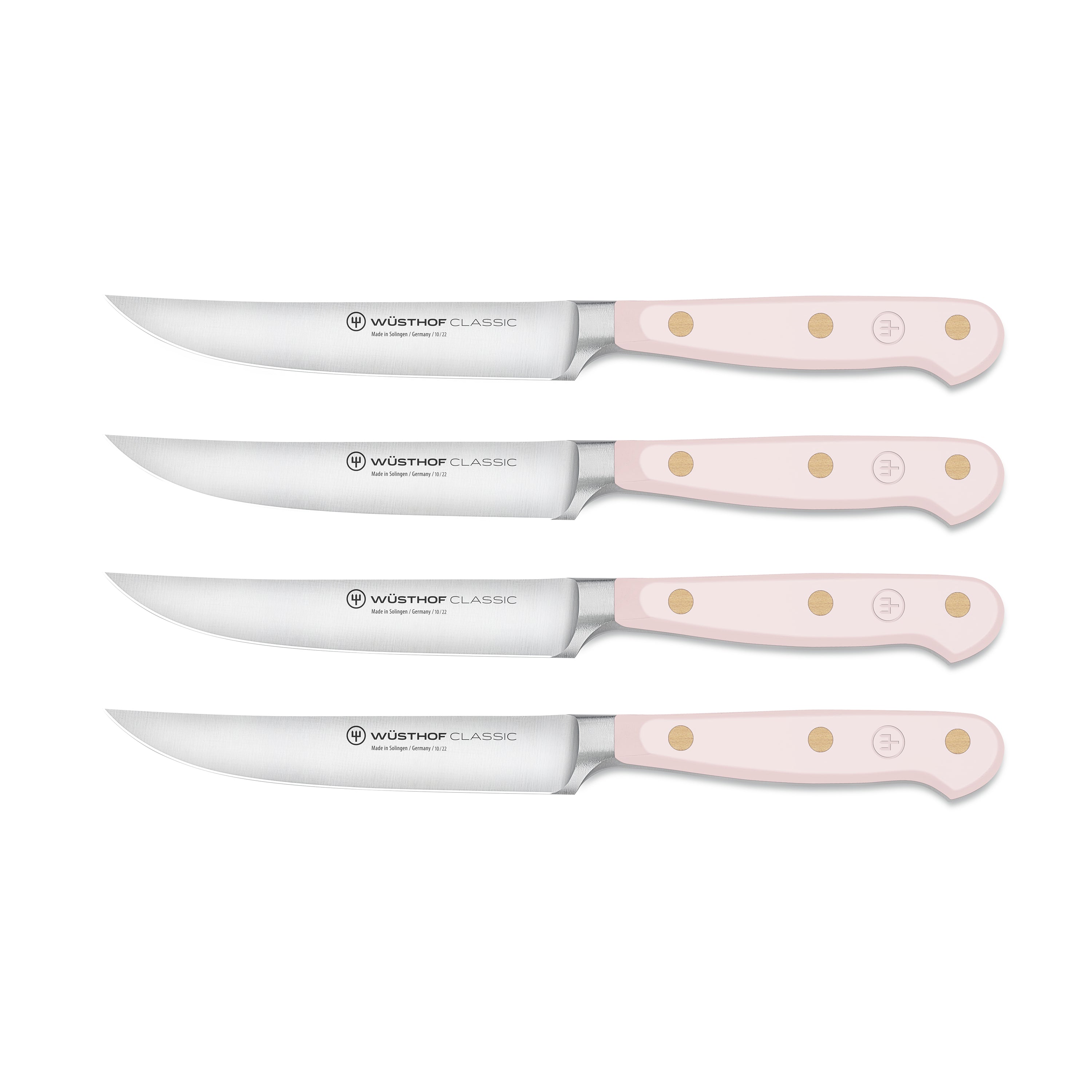 Close-up of pink Himalayan salt steak knives with sharp blades and stylish handles