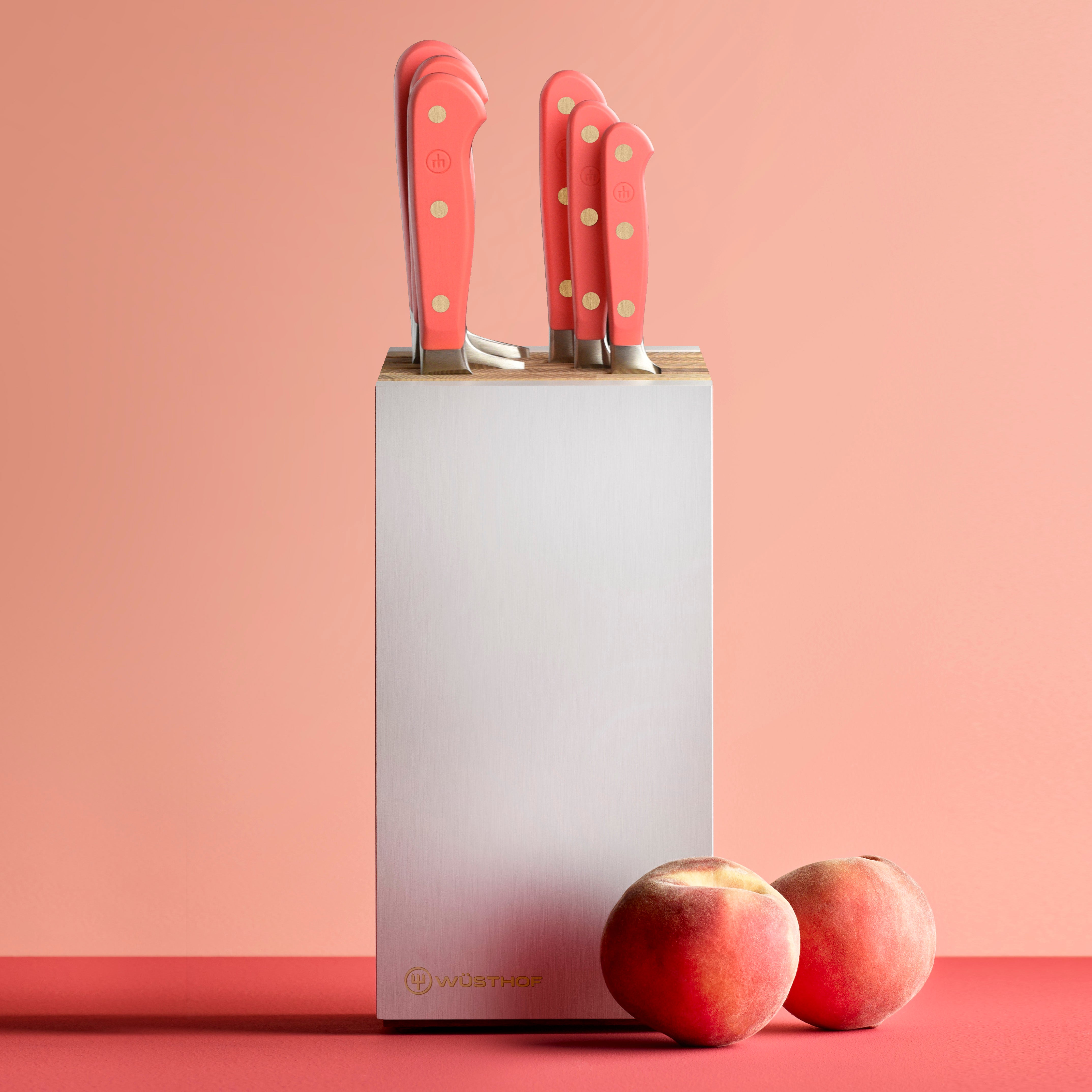 Wusthof Classic 8-Piece Knife Block Set with vibrant coral peach block, highlighting the superior craftsmanship and design.