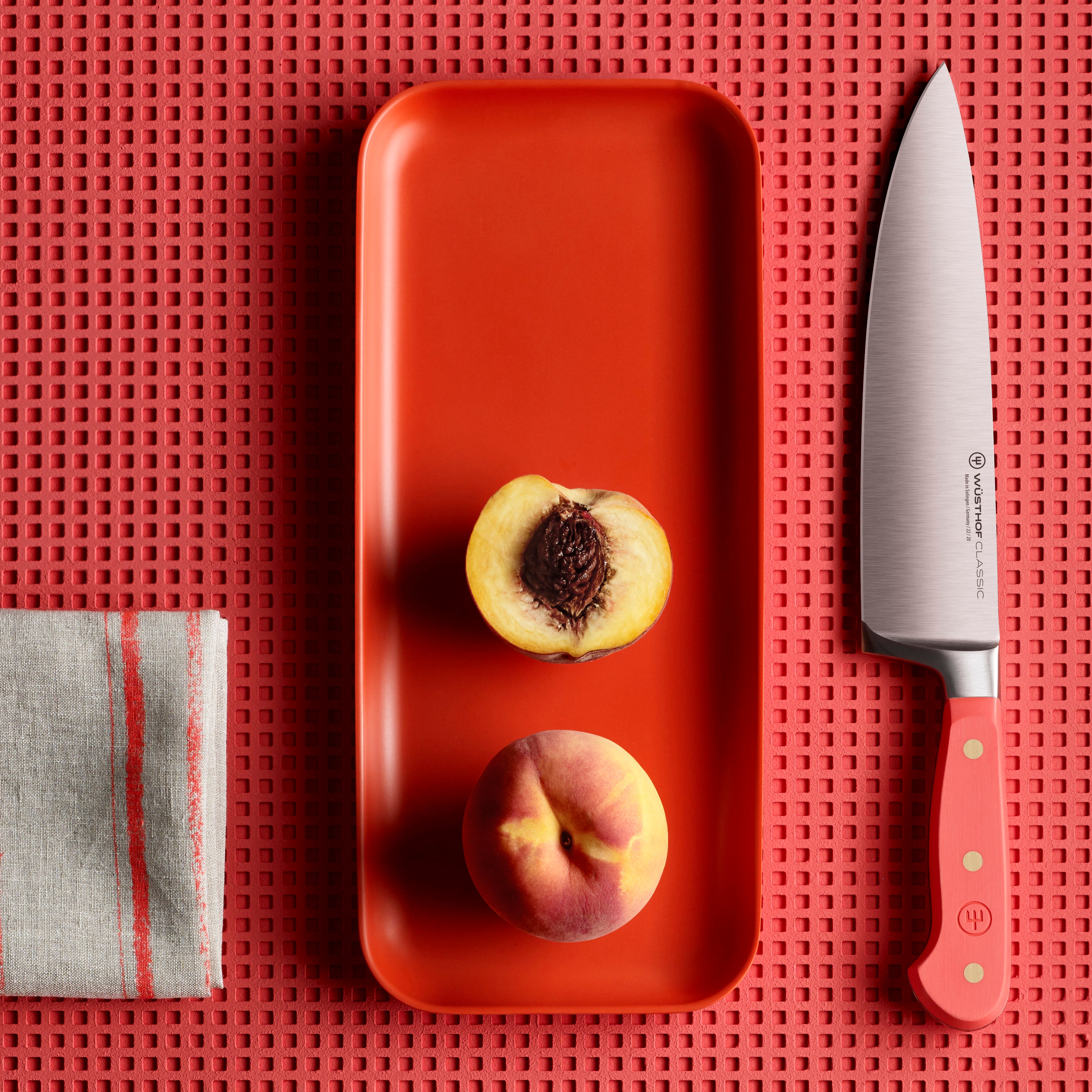 Wusthof Classic 8-Piece Knife Block Set with vibrant coral peach block, highlighting the superior craftsmanship and design.