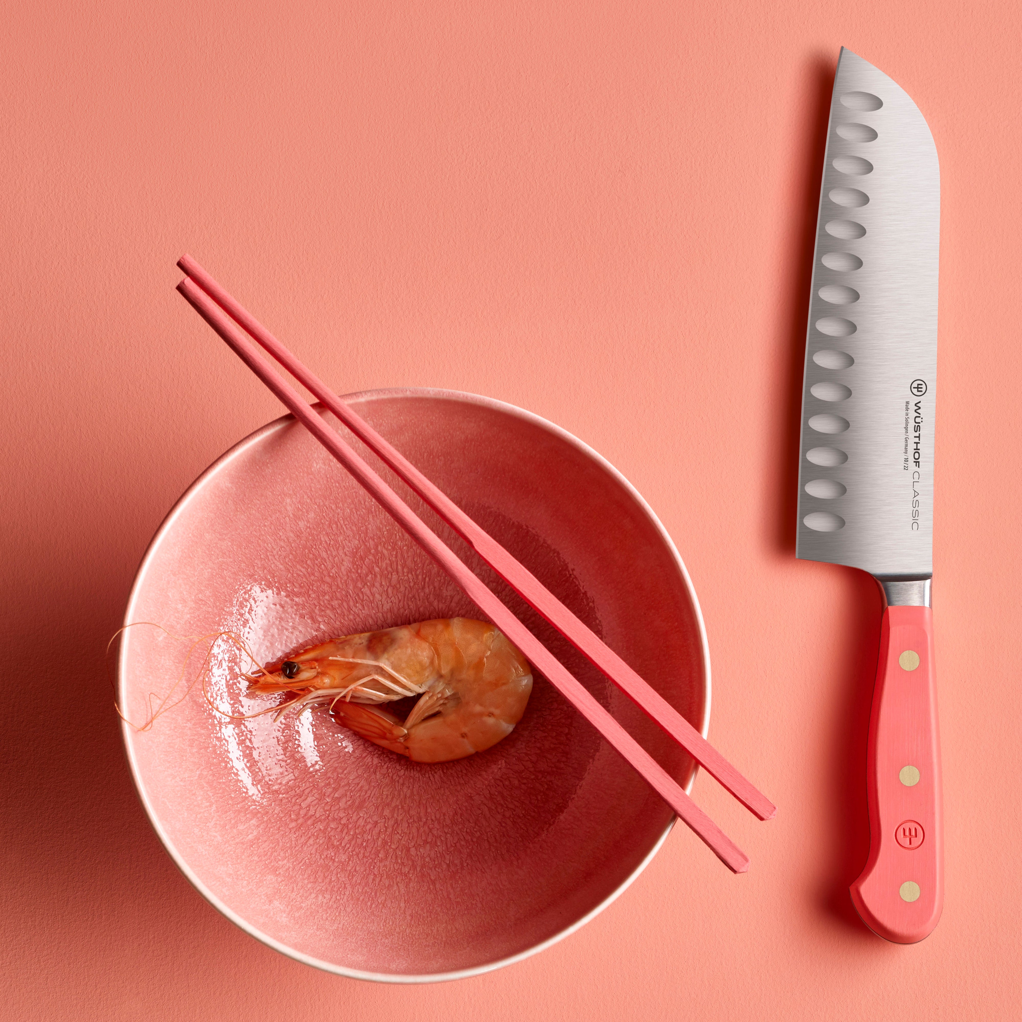 Top view of the Wüsthof Santoku knife with full tang and brass rivets in a professional kitchen