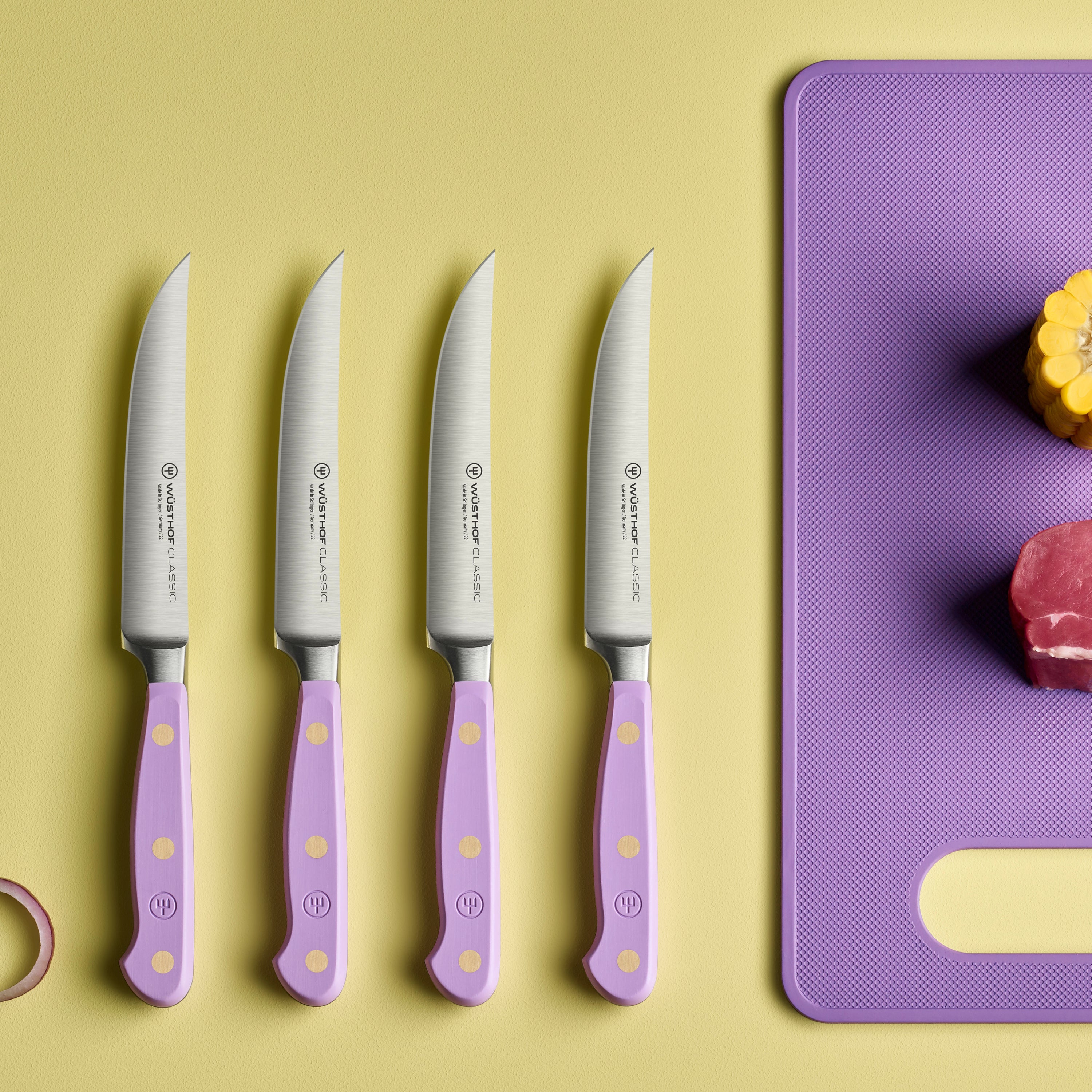 Angled overhead shot of the full premium forged steak knife set arranged in open gift box