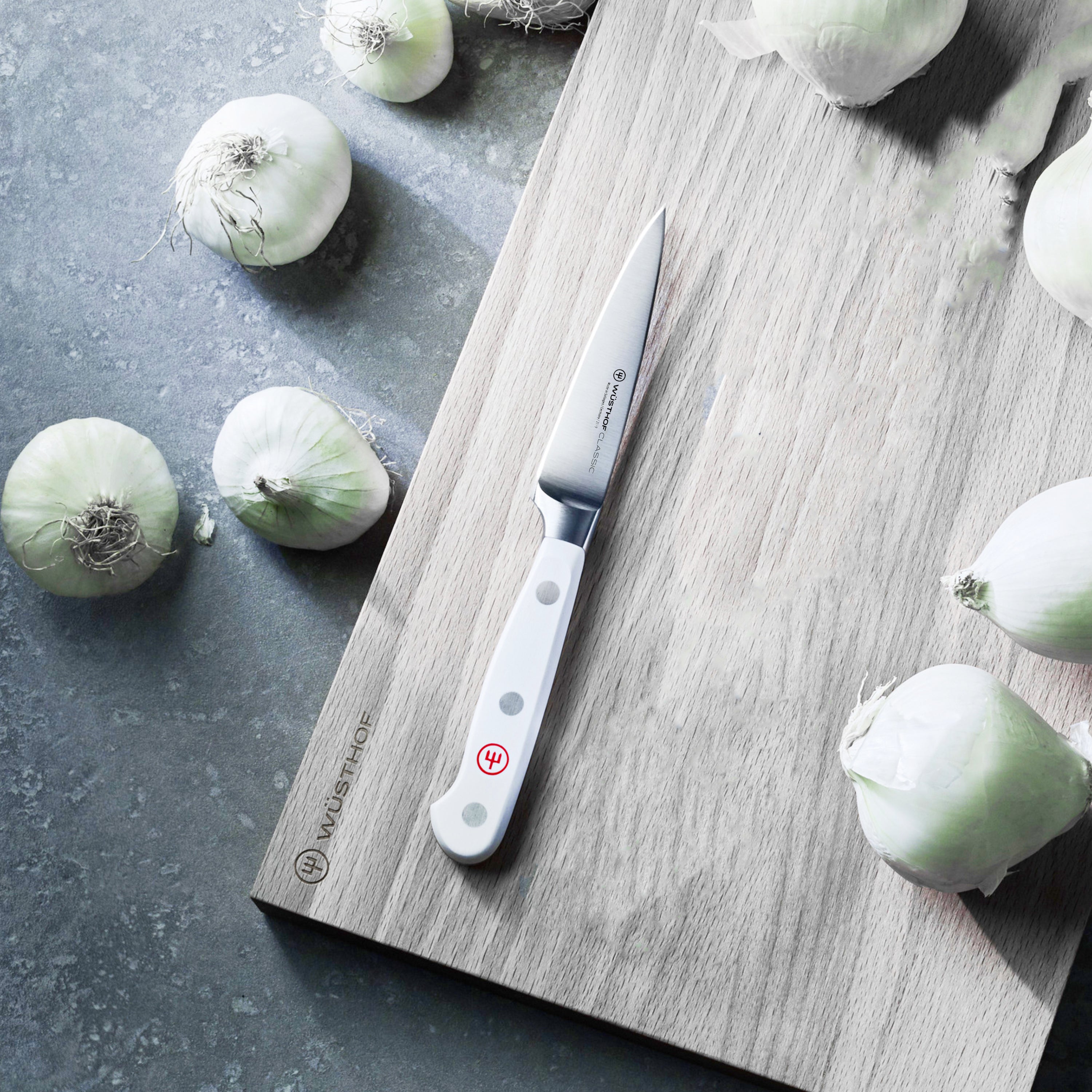 Close-up of the Wusthof Precision White Paring Knife, displaying the high-carbon stainless steel blade and POM handle.