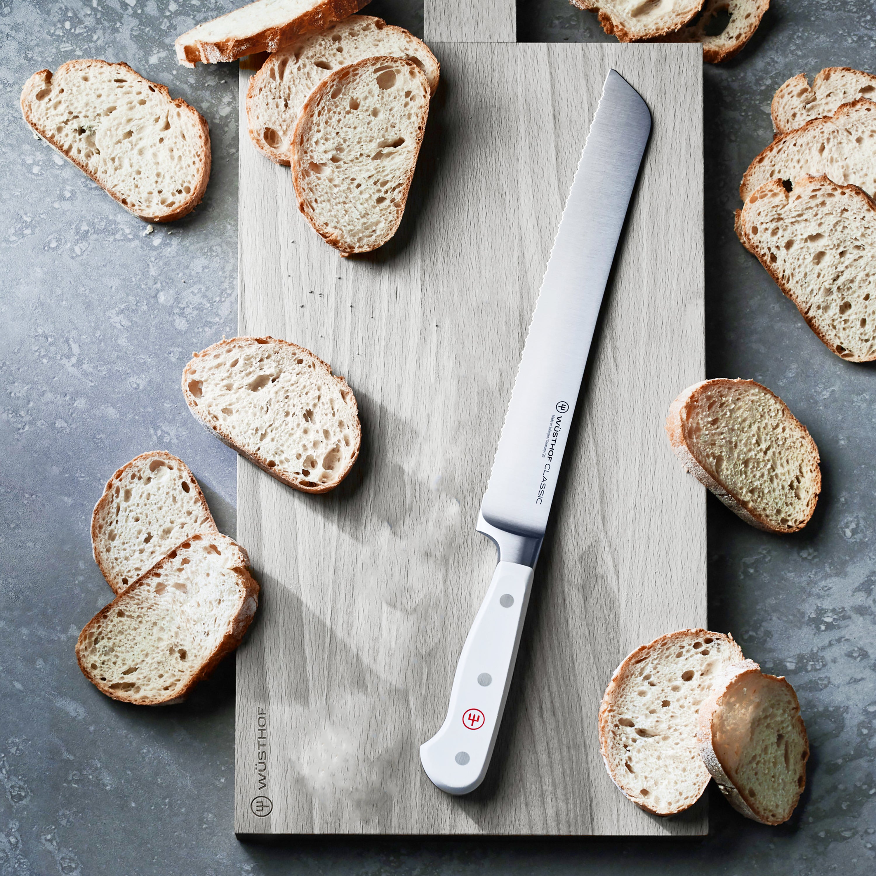 Wusthof Classic White 9-inch serrated bread knife slicing crusty artisanal bread